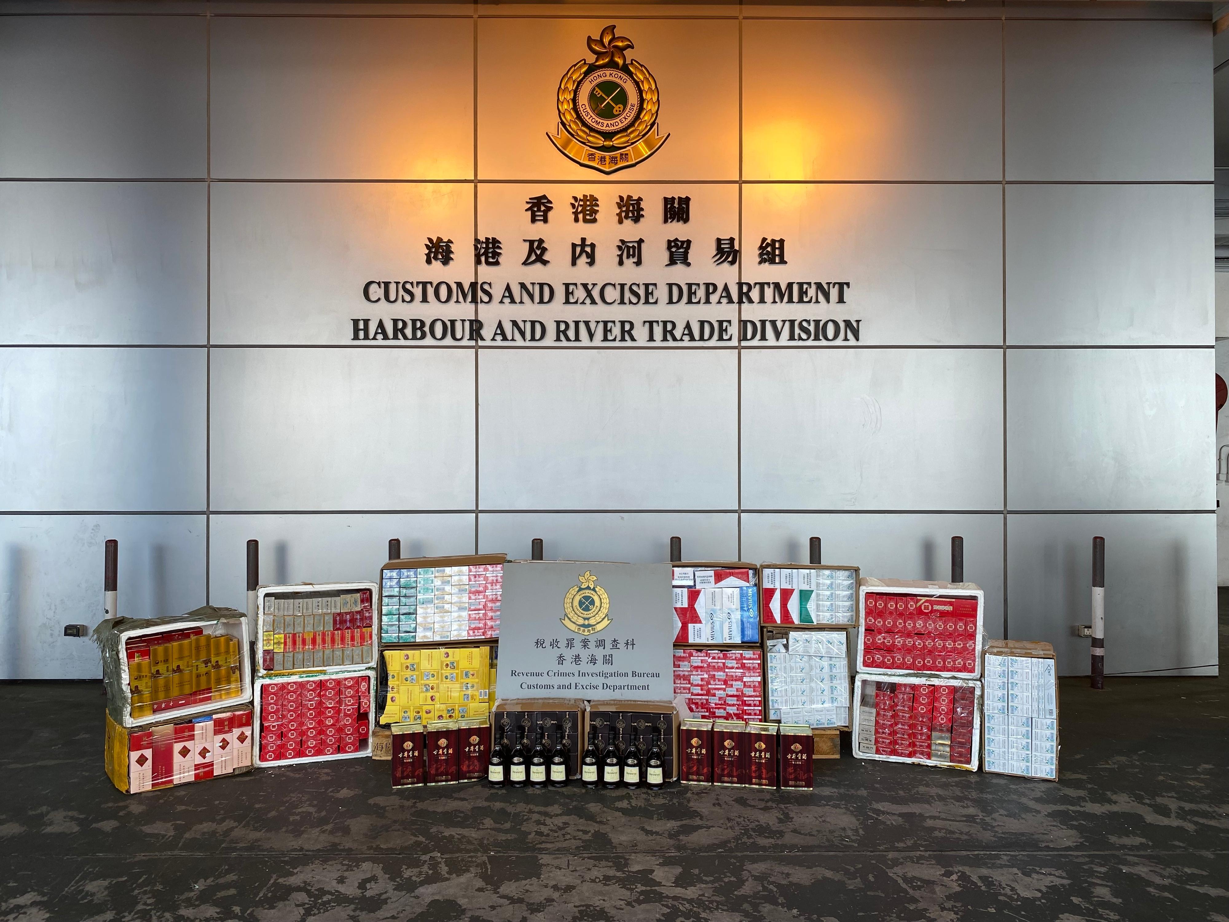 Hong Kong Customs on February 8 and 13 seized a batch of suspected smuggled tobacco products and liquor at the Tuen Mun River Trade Terminal Customs Cargo Examination Compound. It included about 1.5 million suspected illicit cigarettes, about 3 600 kilograms of suspected duty-not-paid manufactured tobacco and about 20 litres of suspected duty-not-paid liquor. The total estimated market value was about $14 million, with a duty potential of about $11 million. Photo shows the suspected smuggled tobacco products and liquor seized by Customs officers on February 13.