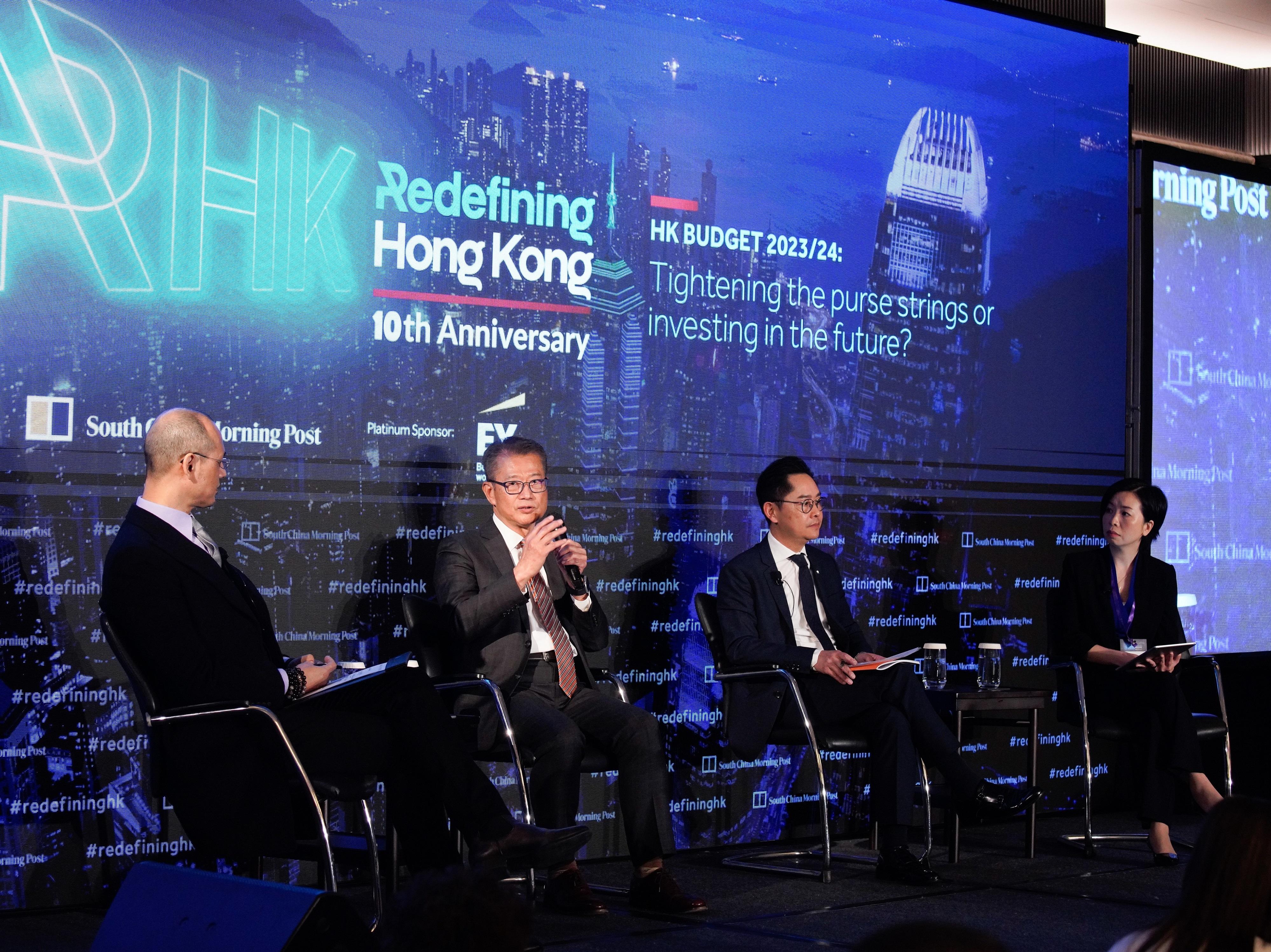 The Financial Secretary, Mr Paul Chan, attended the South China Morning Post's Redefining Hong Kong Series seminar on "HK Budget 2023/24: Tightening the Purse Strings or Investing in the Future?" today (February 27). Photo shows Mr Chan (second left) exchanging views with panellists.