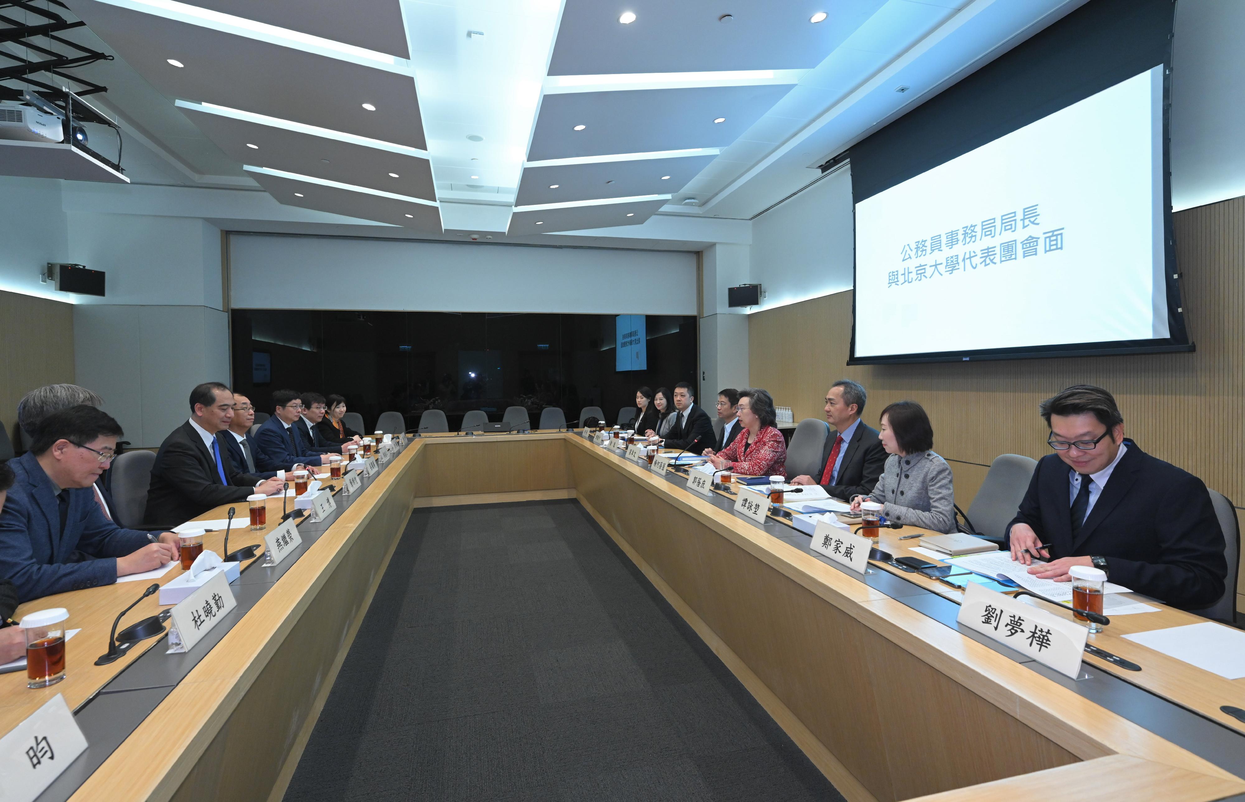 The Secretary for the Civil Service, Mrs Ingrid Yeung (fourth right), met with the delegation from Peking University led by its President, Mr Gong Qihuang (third left), at the Central Government Offices today (March 3) to exchange views on civil service training for the Hong Kong Special Administrative Region Government. Photo shows Mrs Yeung introducing to the delegation the major initiatives of civil service training. Both sides also discussed future collaboration plans. The Permanent Secretary for the Civil Service, Mr Clement Leung (fifth right), and the Head of the Civil Service College, Mr Oscar Kwok (third right), also joined the meeting. 
