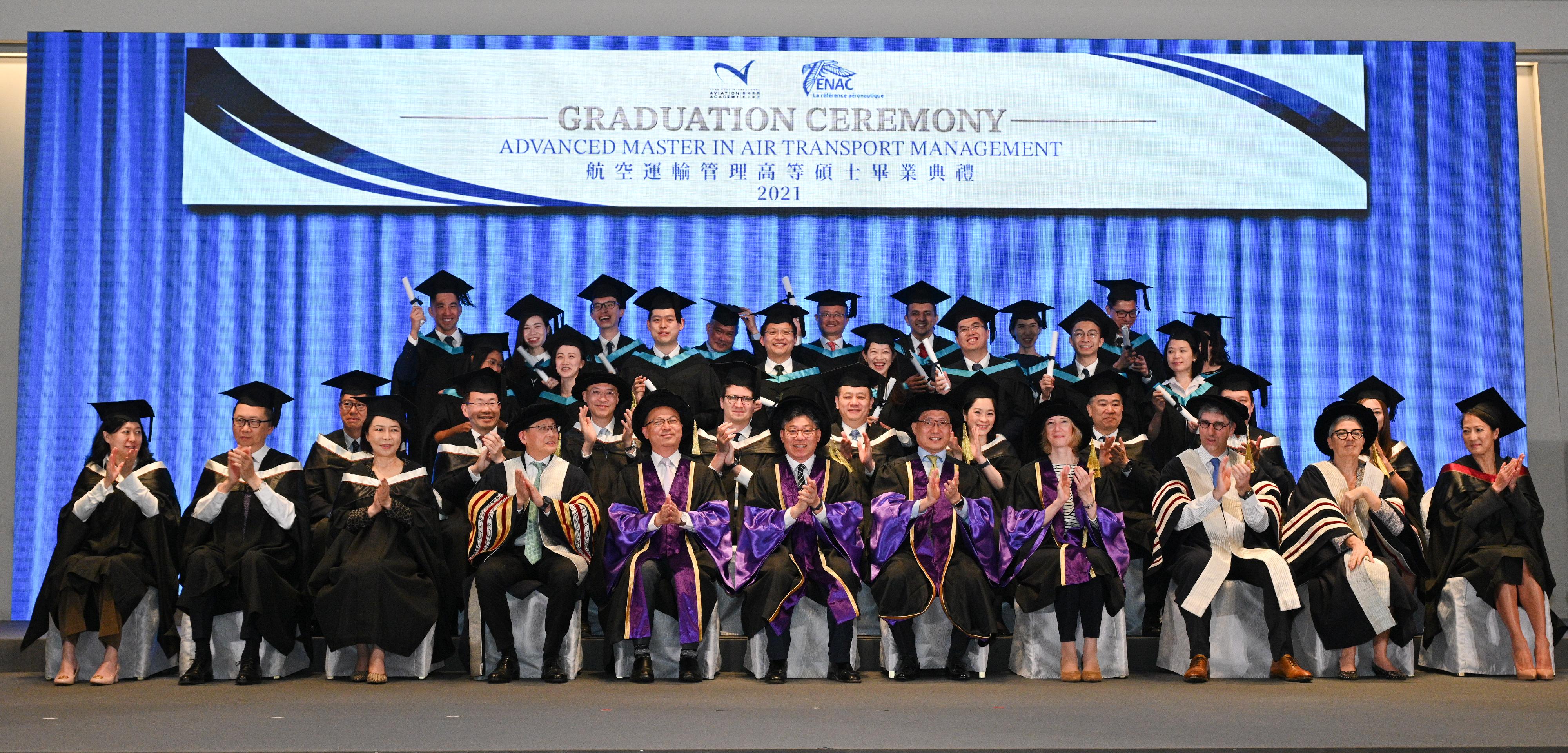 The Secretary for Transport and Logistics, Mr Lam Sai-hung (centre, front row), today (March 10) attended the Hong Kong International Aviation Academy's Graduation Ceremony for the 2021 Cohort of the Advanced Master Programme in Air Transport Management. Photo shows Mr Lam with other officiating guests and the graduates.