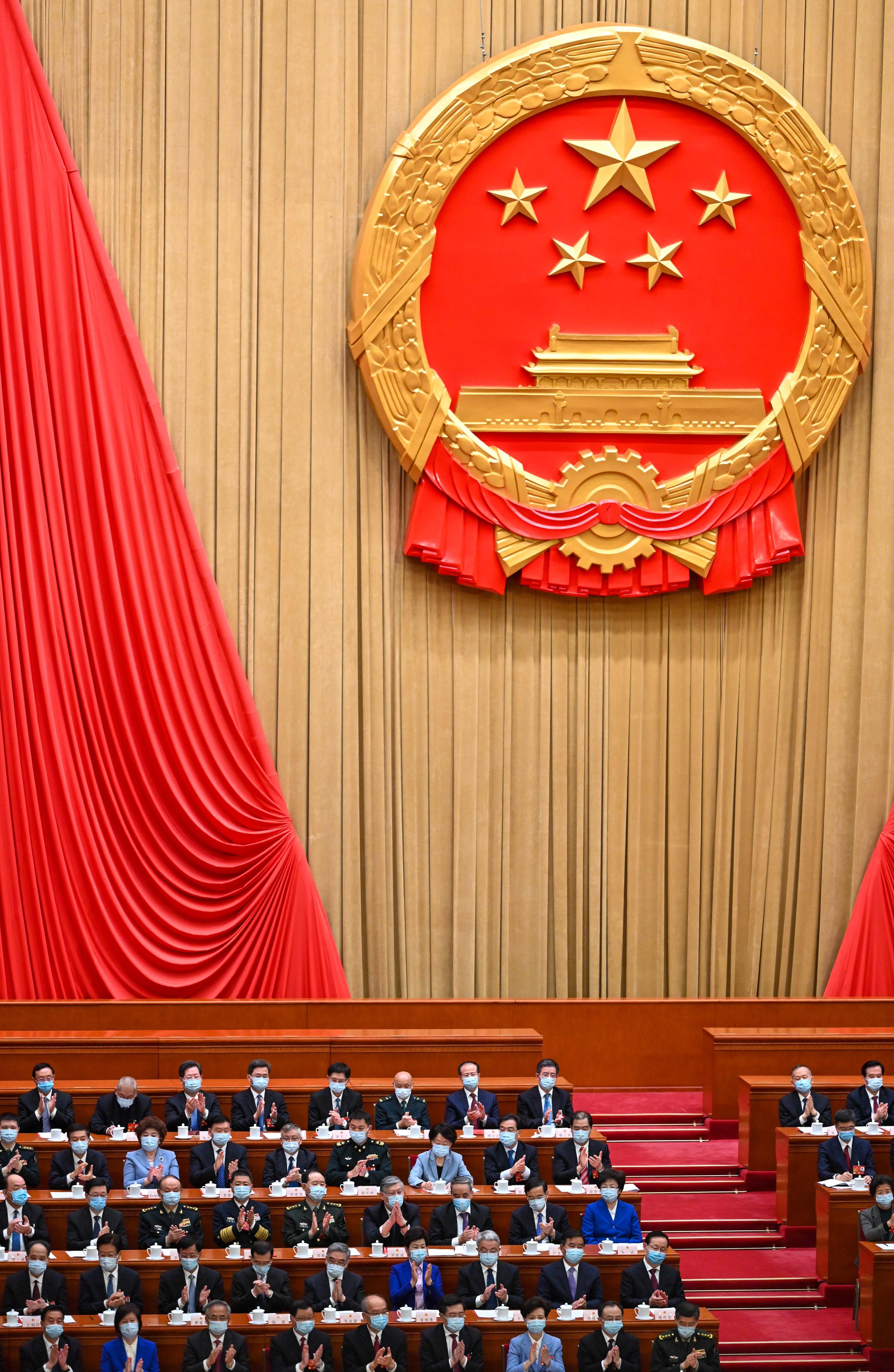 The Chief Executive, Mr John Lee (third row, second left), attends the closing meeting of the first session of the 14th National People's Congress in Beijing this morning (March 13).
