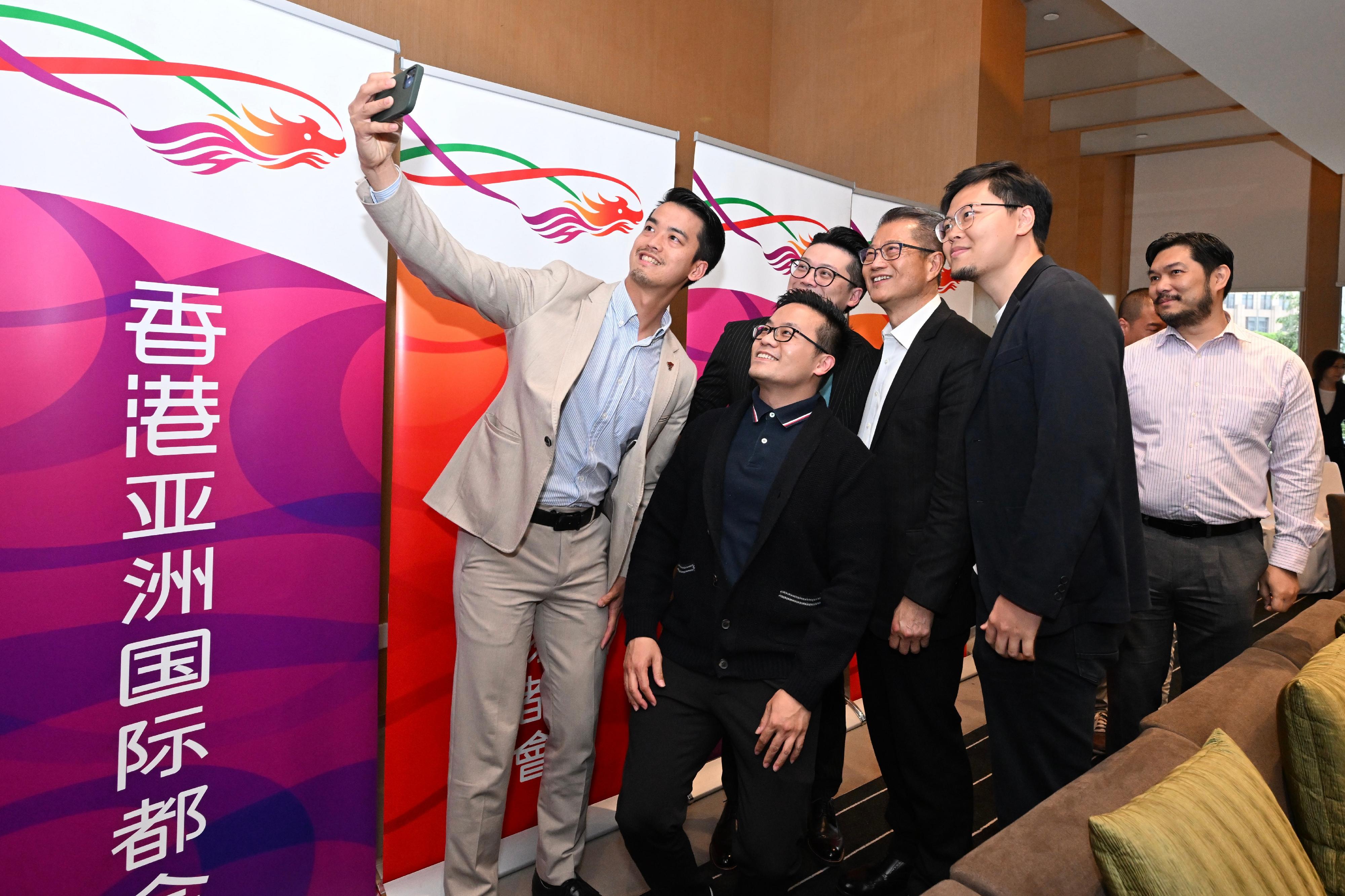 財政司司長陳茂波今日（三月十五日）到訪廣州市，與在穗的香港青年企業家舉行座談會，交流意見。圖示陳茂波（右三）與香港青年企業家自拍留念。