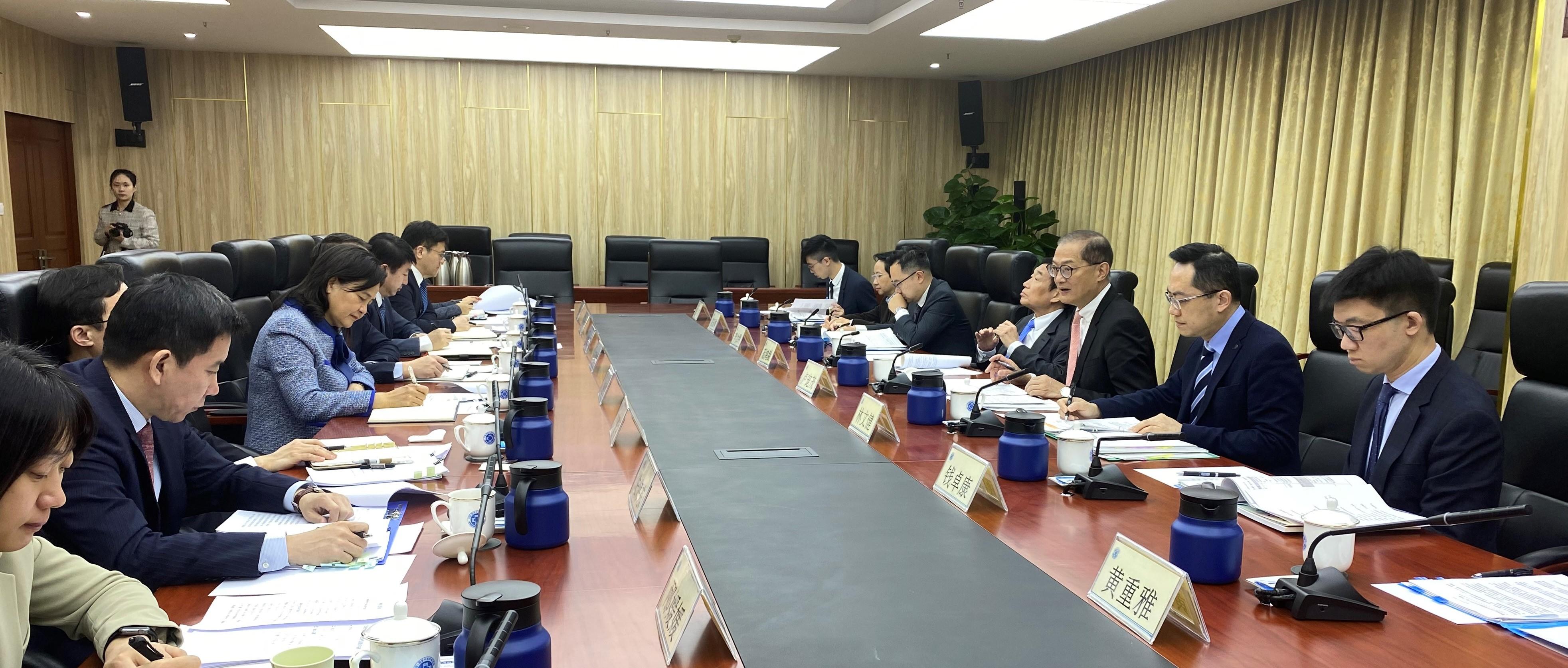 The Secretary for Health, Professor Lo Chung-mau and his delegation called on the National Administration of Traditional Chinese Medicine (NATCM) today (March 16). Photo shows Professor Lo (third right) in a meeting with the Party Secretary and Vice Commissioner of the NATCM, Professor Yu Yanhong (fourth left), with the Director of Health, Dr Ronald Lam (second right); Deputy Secretary for Health Mr Eddie Lee (fifth right); and the Chairman of the Hospital Authority, Mr Henry Fan (fourth right), in attendance.