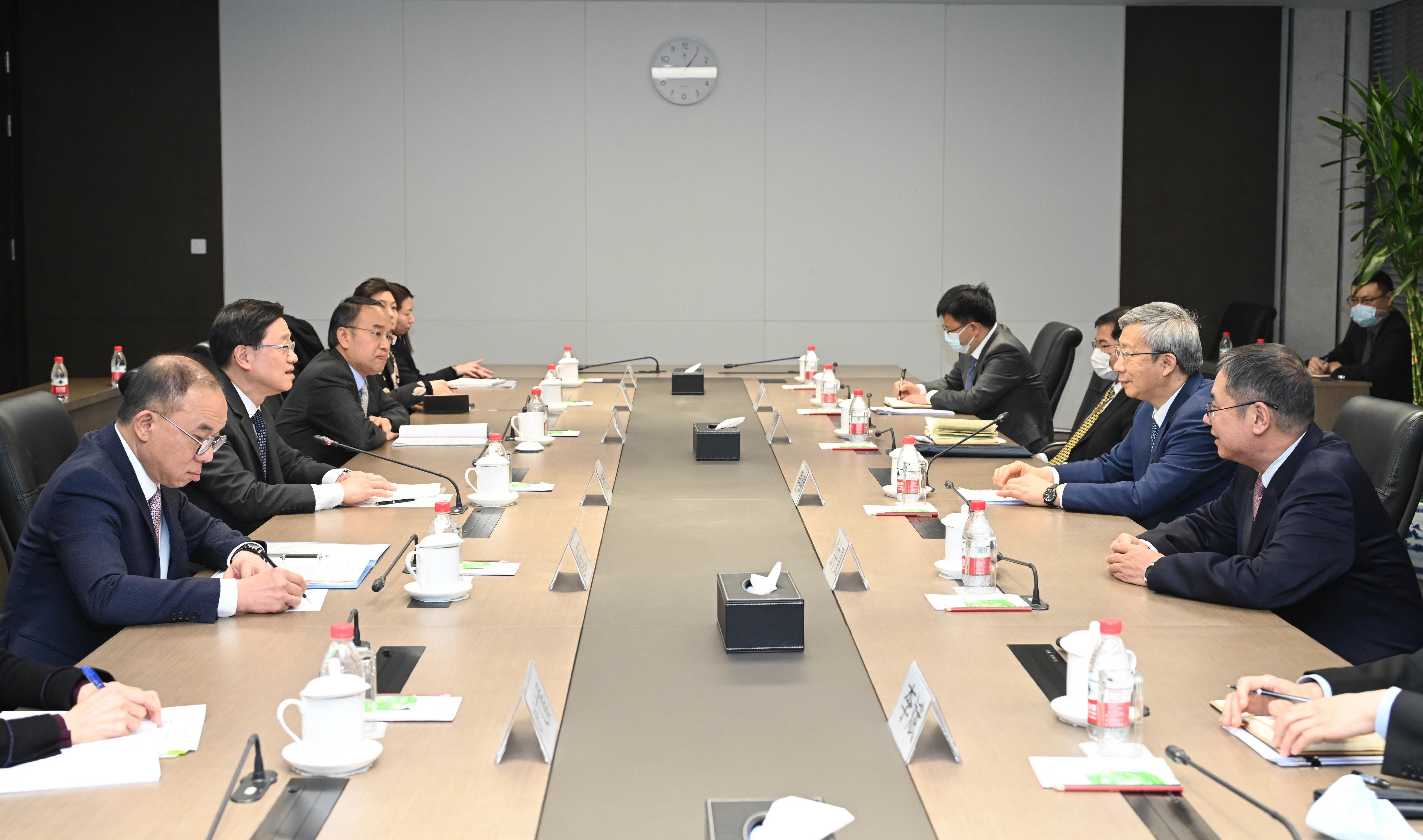 The Chief Executive, Mr John Lee (second left), meets with the Governor of the People's Bank of China, Mr Yi Gang (second right), in Beijing today (March 17). Also joining the meeting are the Secretary for Constitutional and Mainland Affairs, Mr Erick Tsang Kwok-wai (first left), and the Secretary for Financial Services and the Treasury, Mr Christopher Hui (third left).