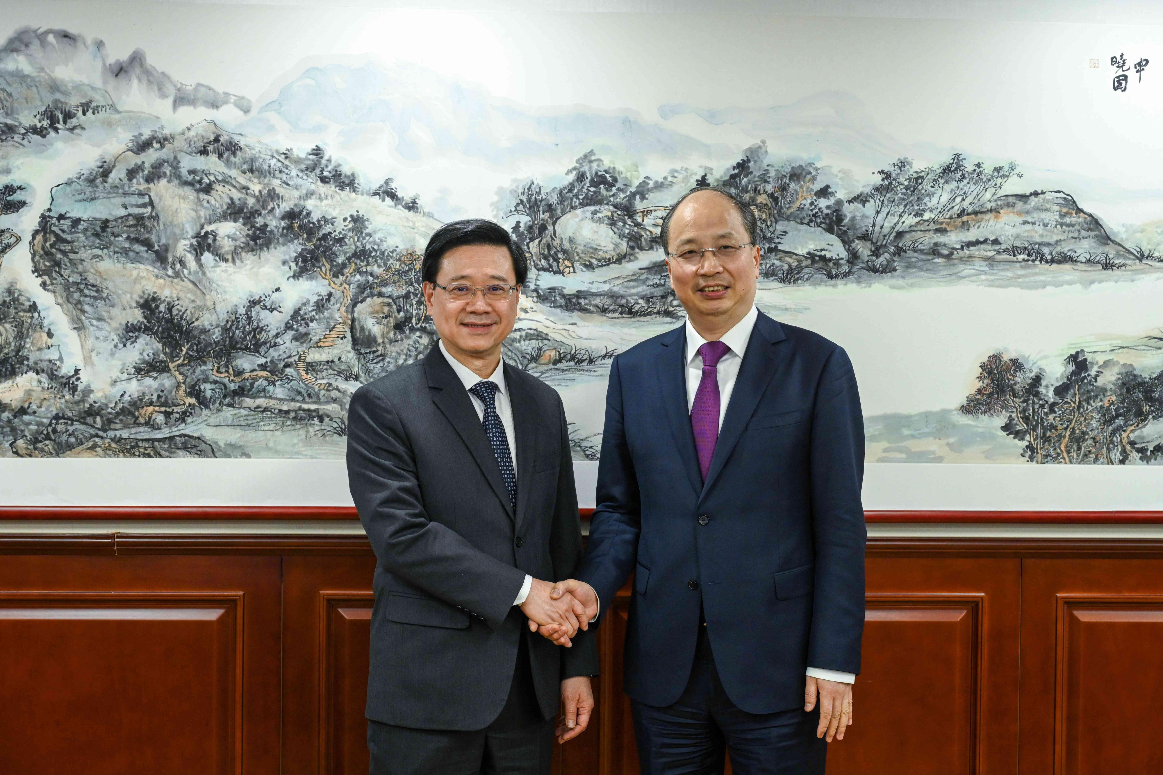 The Chief Executive, Mr John Lee (left), meets with the Chairman of the China Securities Regulatory Commission, Mr Yi Huiman (right), in Beijing today (March 17). 