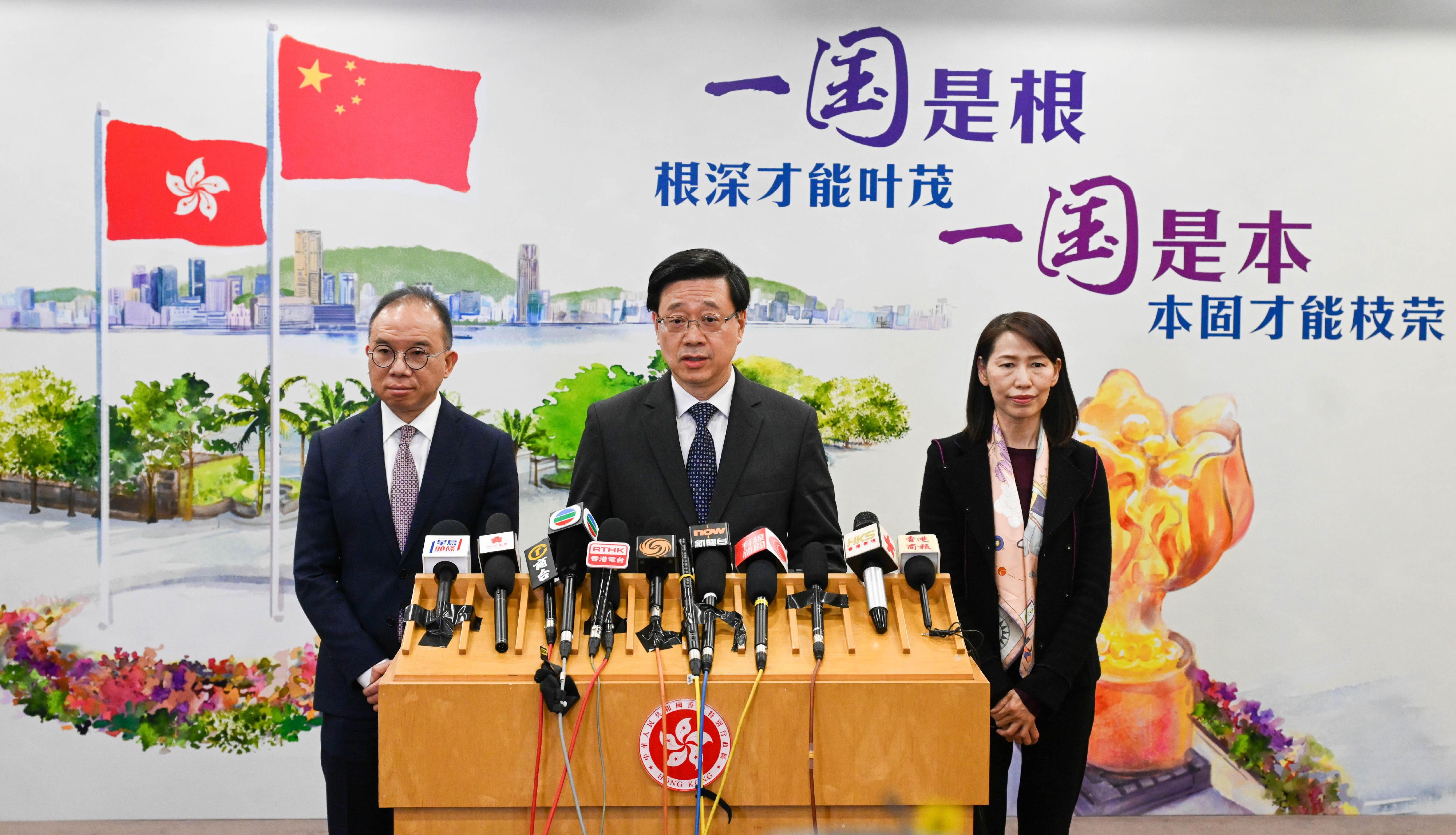 The Chief Executive, Mr John Lee (centre), accompanied by the Secretary for Constitutional and Mainland Affairs, Mr Erick Tsang Kwok-wai (left), and the Director of the Chief Executive's Office, Ms Carol Yip (right), meets the media in Beijing today (March 17).