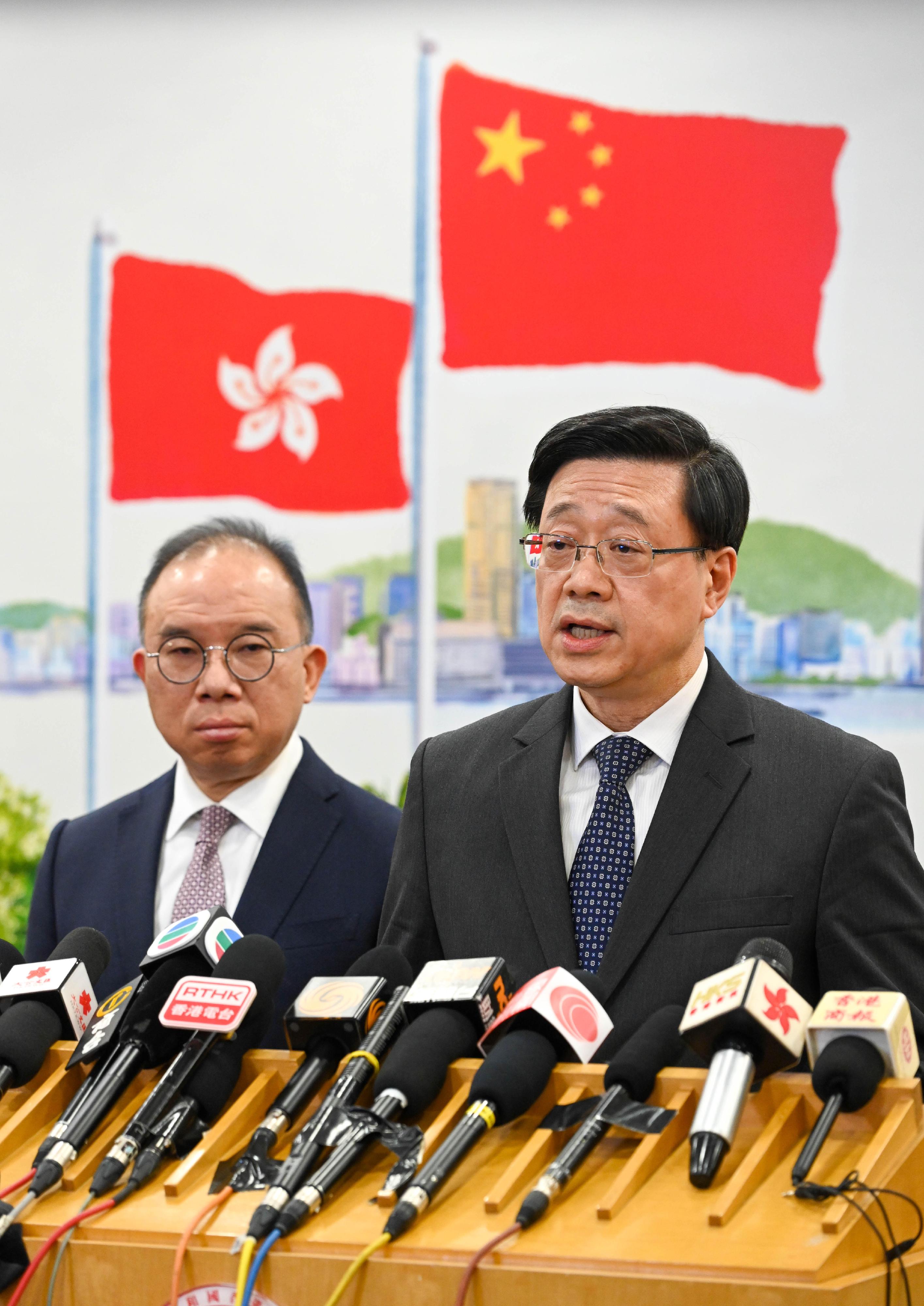 The Chief Executive, Mr John Lee (right), meets the media in Beijing today (March 17). Looking on is the Secretary for Constitutional and Mainland Affairs, Mr Erick Tsang Kwok-wai (left).