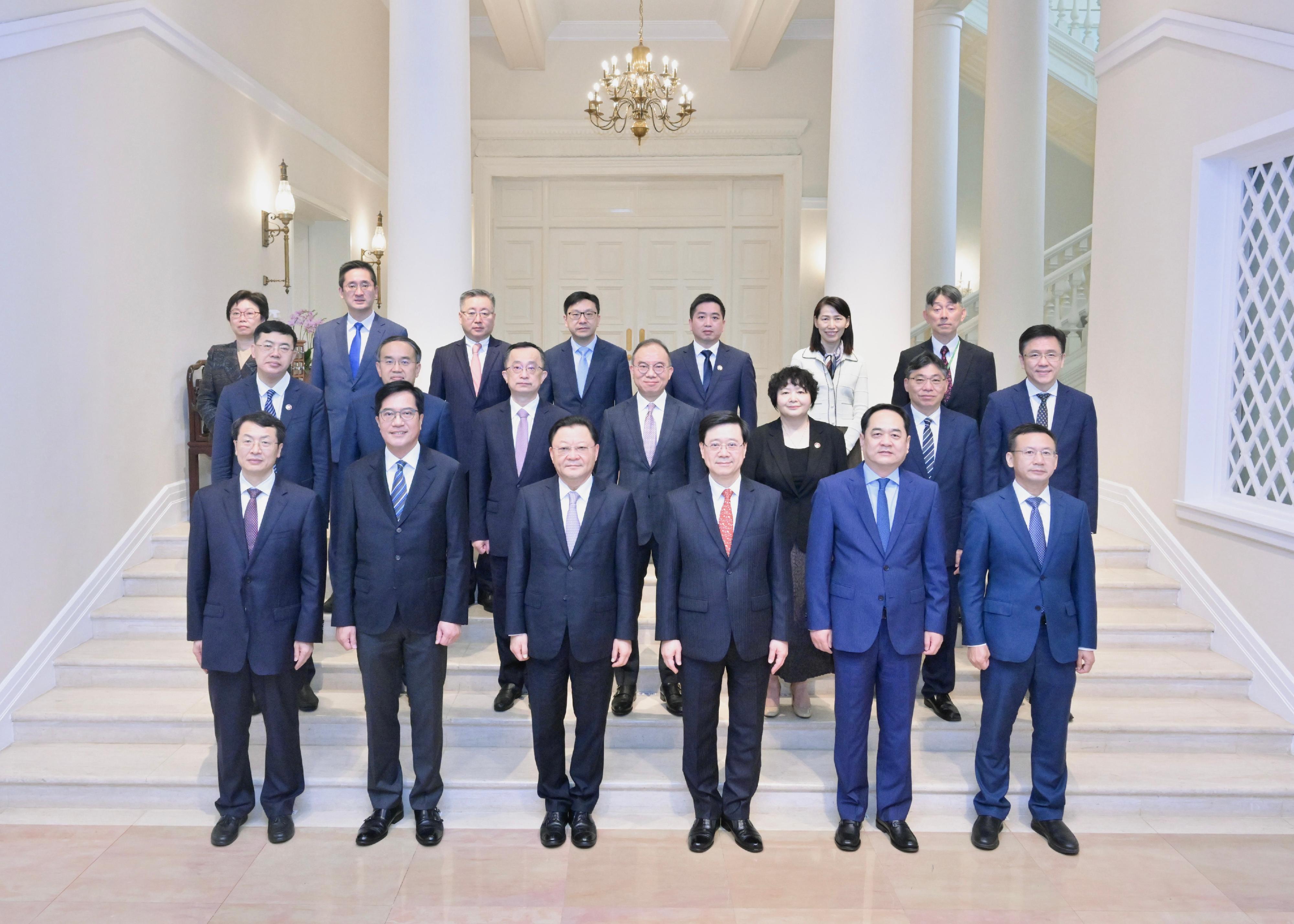 The Chief Executive, Mr John Lee, hosted a lunch at Government House for the visiting delegation of Guangdong Province attending the 23rd Plenary of Hong Kong/Guangdong Co-operation Joint Conference today (March 21). Photo shows Mr Lee (first row, third right); the Governor of Guangdong Province, Mr Wang Weizhong (first row, third left); Deputy Director of the Hong Kong and Macao Affairs Office of the State Council Mr Yang Wanming (first row, second right); the Deputy Financial Secretary, Mr Michael Wong (first row, second left); the Secretary for Constitutional and Mainland Affairs, Mr Erick Tsang Kwok-wai (second row, centre); the Secretary for Financial Services and the Treasury, Mr Christopher Hui (second row, second left); the Secretary for Transport and Logistics, Mr Lam Sai-hung (second row, second right); the Secretary for Innovation, Technology and Industry, Professor Sun Dong (second row, first right); the Secretary for Labour and Welfare, Mr Chris Sun (third row, fourth left), and other representatives of the Hong Kong Special Administrative Region Government and Guangdong Province delegation members at Government House.

