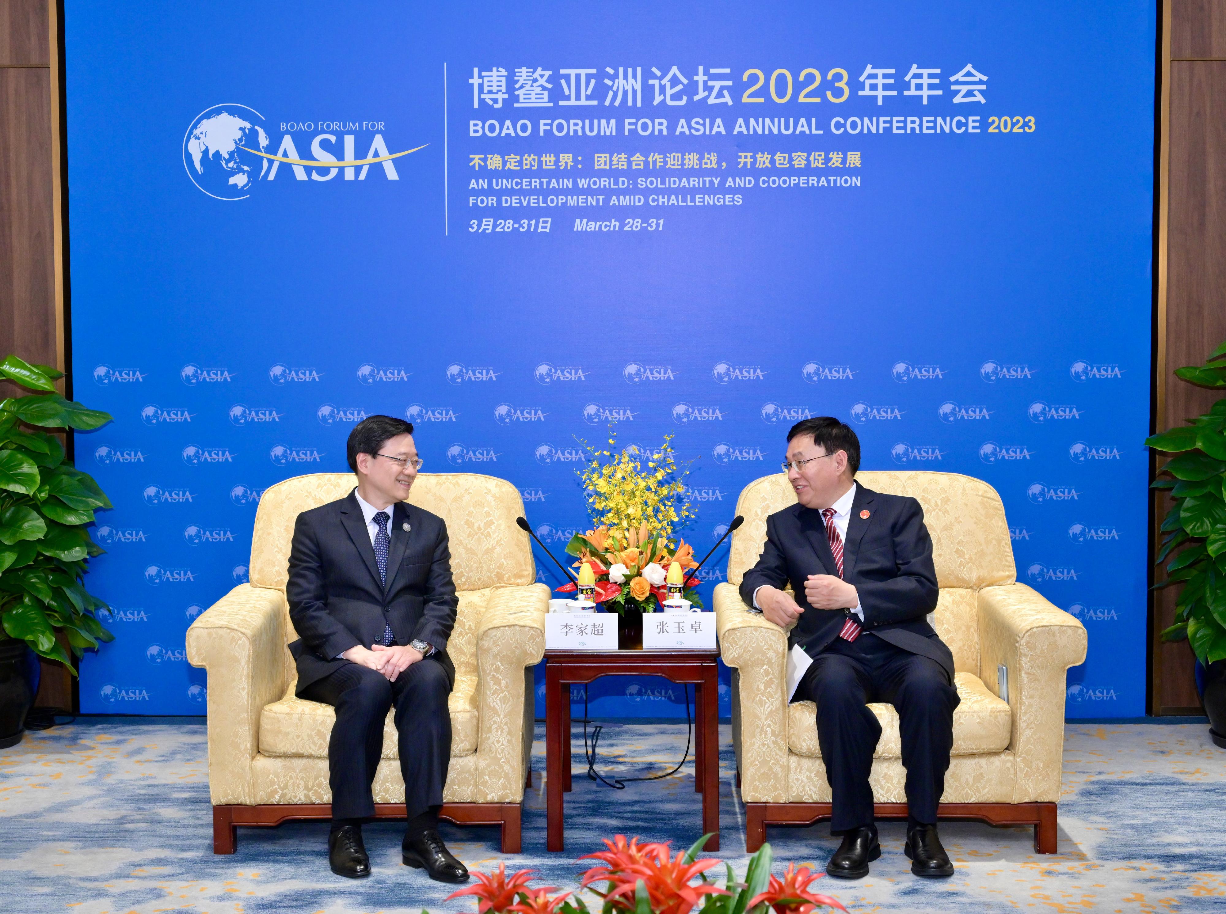 The Chief Executive, Mr John Lee (left), meets with the Chairman of the State-owned Assets Supervision and Administration Commission of the State Council, Mr Zhang Yuzhuo (right), during the Boao Forum for Asia Annual Conference 2023 in Hainan today (March 30).
