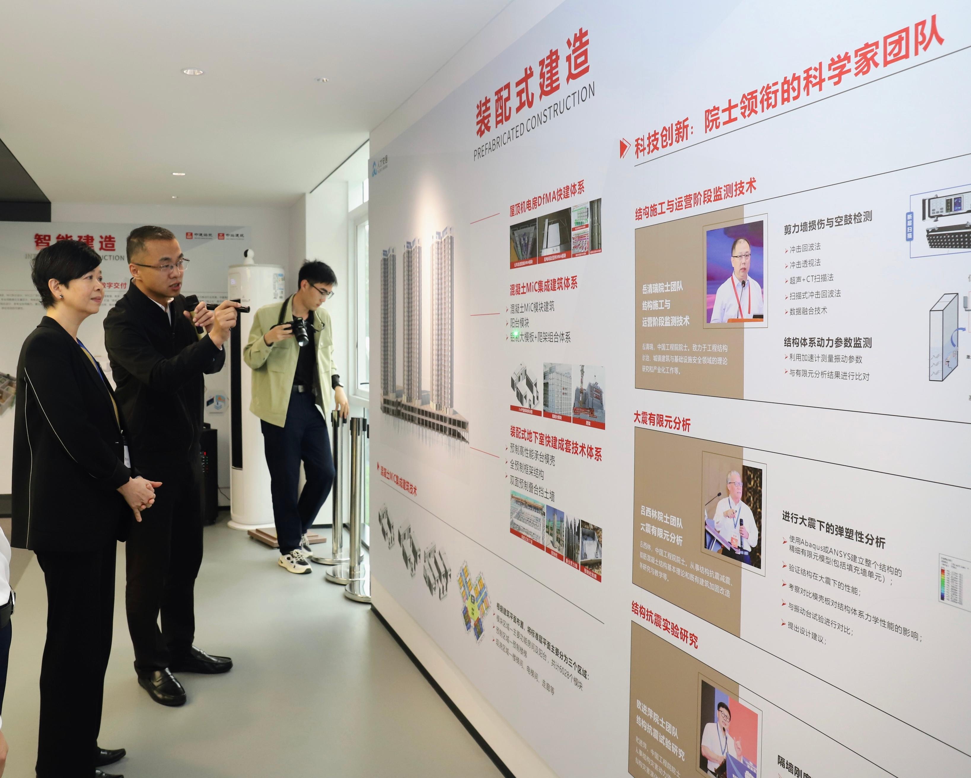 The Secretary for Housing, Ms Winnie Ho, led representatives of the Housing Bureau, the Housing Department and the Architectural Services Department to Shenzhen today (April 3). Photo shows Ms Ho (left) visiting an indemnificatory housing project in Zhangkeng, Longhua District, and being briefed on the project which was built expeditiously by adopting the Modular Integrated Construction method as a concrete construction approach.