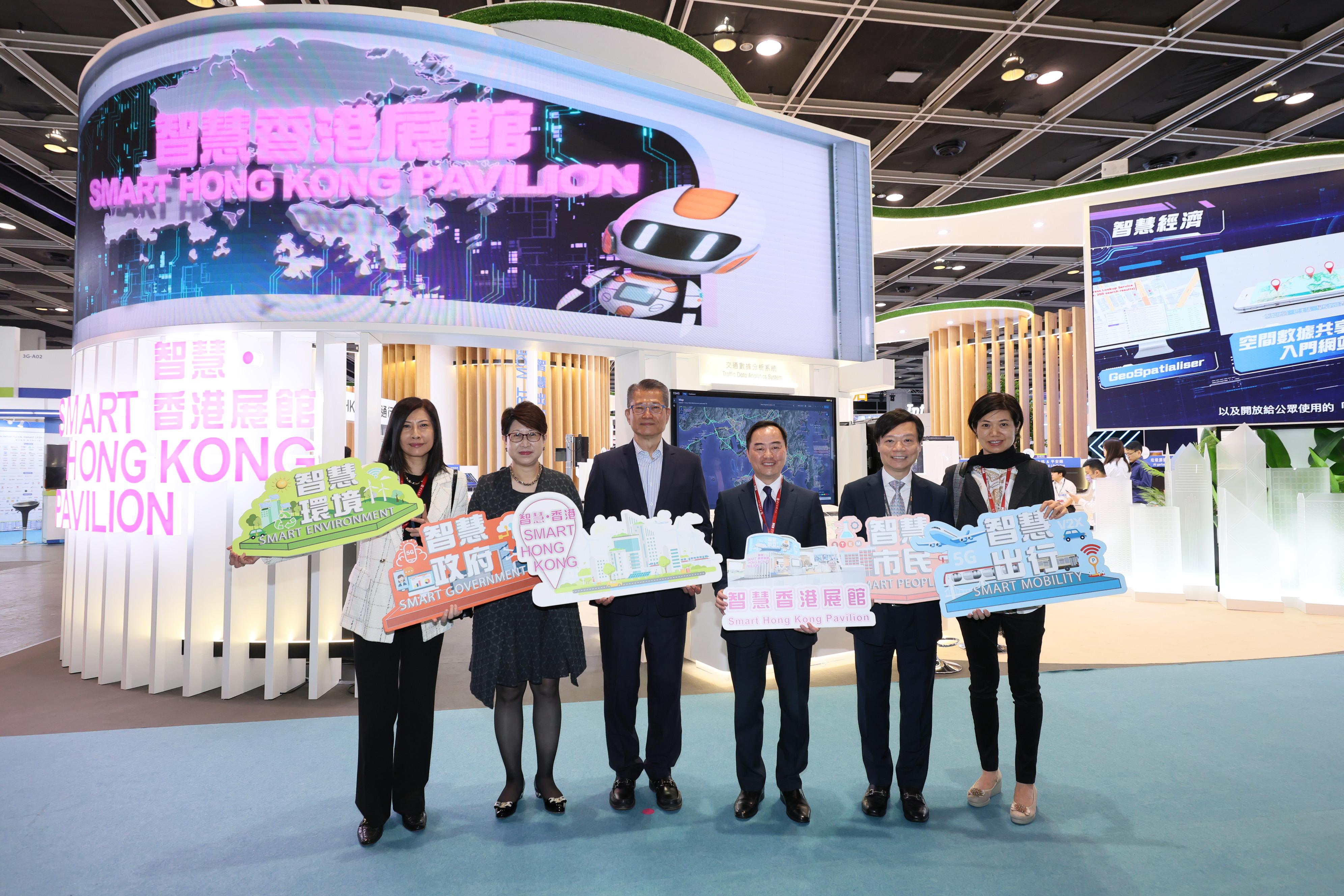 The Financial Secretary, Mr Paul Chan (third left), tours the InnoEX after attending the FinTech Forum of the Digital Economy Summit 2023 today (April 14).
