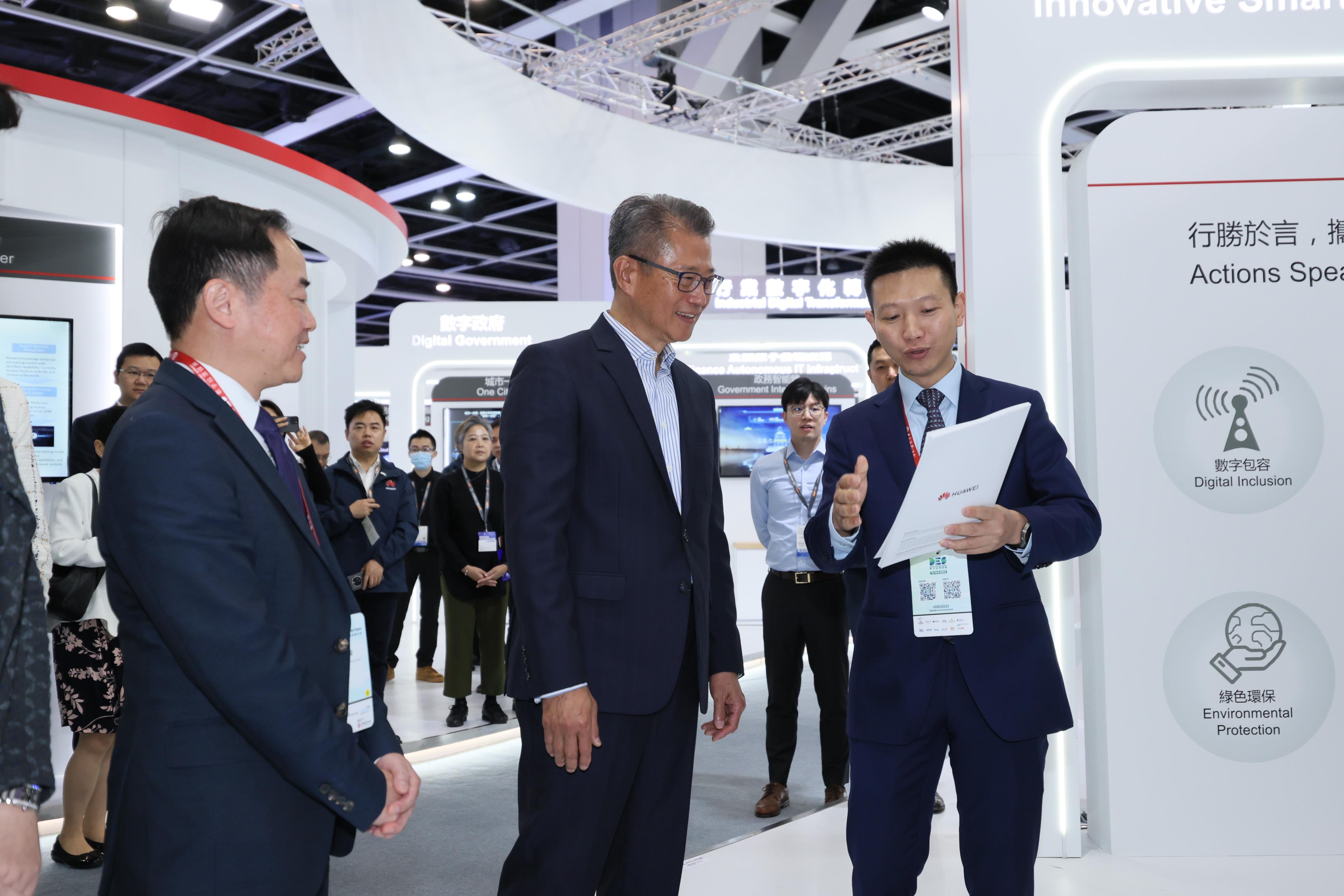 The Financial Secretary, Mr Paul Chan (centre), tours the InnoEX after attending the FinTech Forum of the Digital Economy Summit 2023 today (April 14).