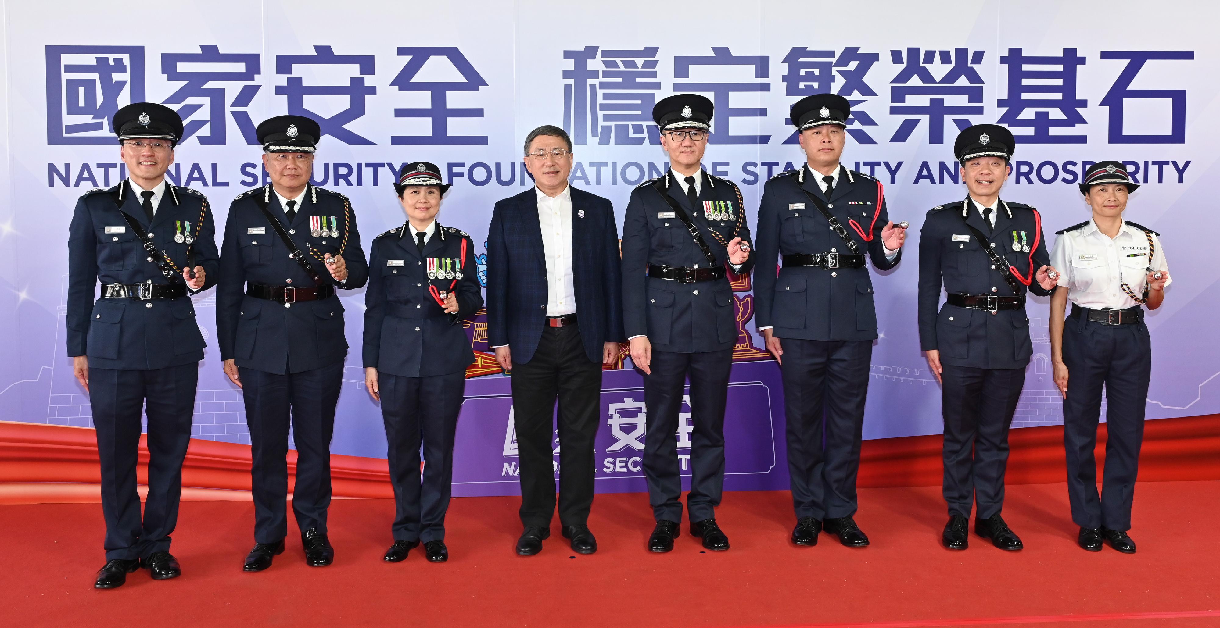 The Deputy Chief Secretary for Administration, Mr Cheuk Wing-hing (fourth left), accompanied by the Commissioner of Police, Mr Siu Chak-yee (fourth right), and other senior officials, attended the grand show of the Police College Open Day in support of the National Security Education Day.