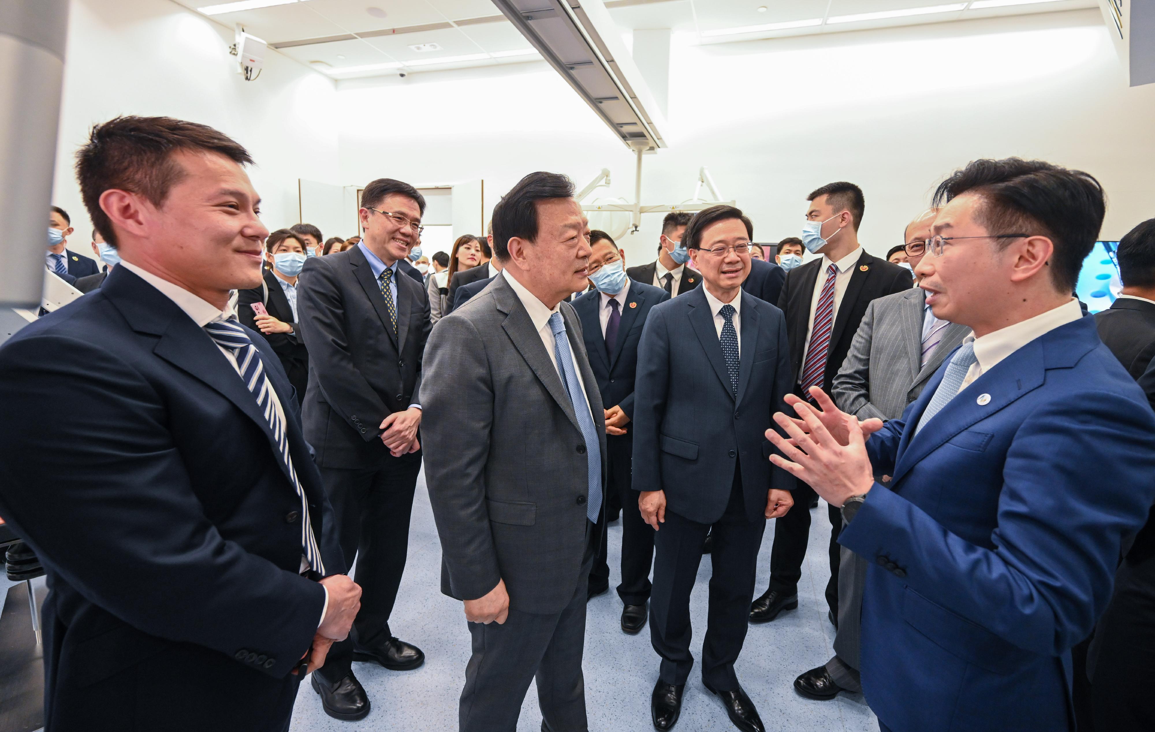 The Vice Chairman of the 13th Chinese People's Political Consultative Conference and Director of the Hong Kong and Macao Affairs Office of the State Council, Mr Xia Baolong, continued his visit in Hong Kong for a fifth day on April 17. Photo shows Mr Xia (centre), accompanied by the Chief Executive, Mr John Lee (second right), and the Secretary for Innovation, Technology and Industry, Professor Sun Dong (second left), visiting the Multi-Scale Medical Robotics Center at the research and development centre of InnoHK at the Hong Kong Science Park.