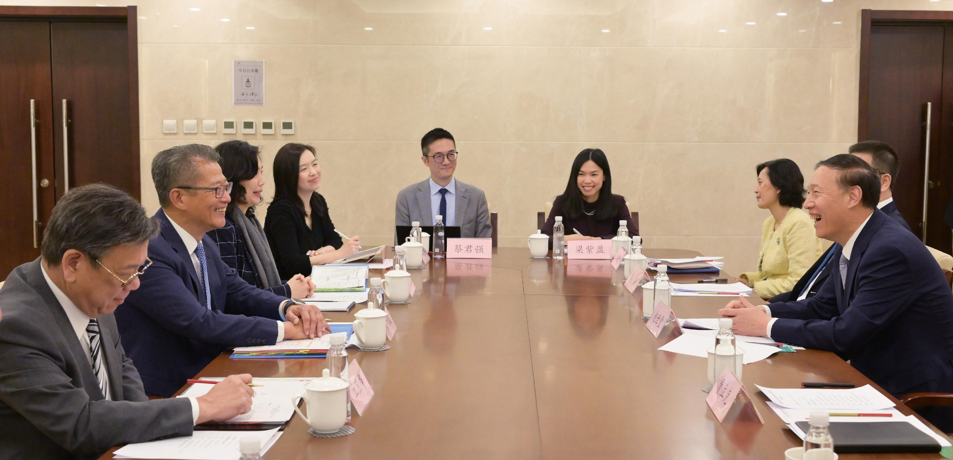 The Financial Secretary, Mr Paul Chan, started his visit programme in Beijing today (April 18). Photo shows Mr Chan (second left) and the Secretary for Commerce and Economic Development, Mr Algernon Yau (first left), meeting with Vice Chairman of the State-owned Assets Supervision and Administration Commission of the State Council Mr Zhao Shitang (first right) in Beijing.