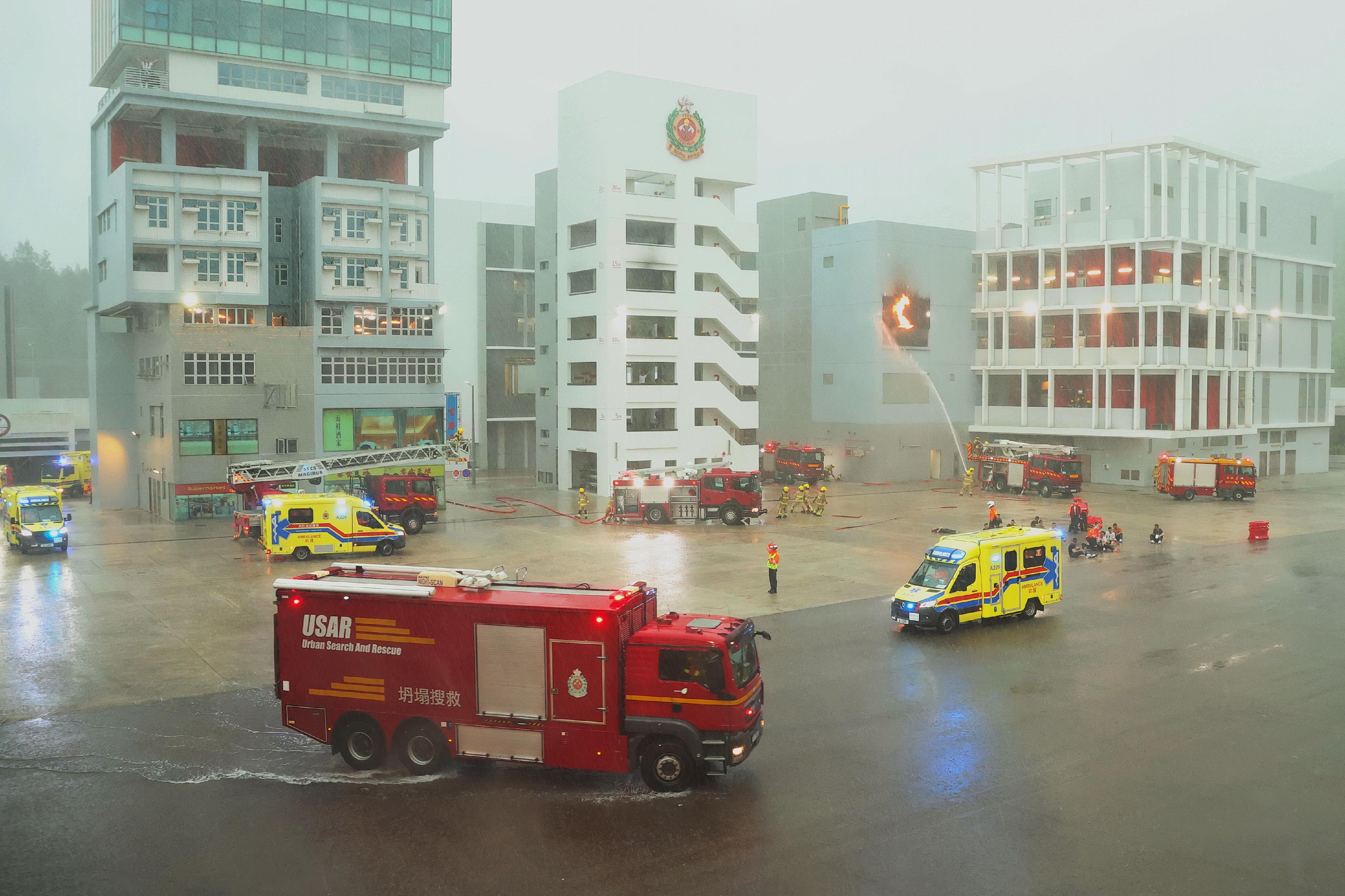 The Chief Executive, Mr John Lee, reviewed the Fire Services passing-out parade at the Fire and Ambulance Services Academy today (April 19). Photo shows graduates demonstrating firefighting and rescue techniques.