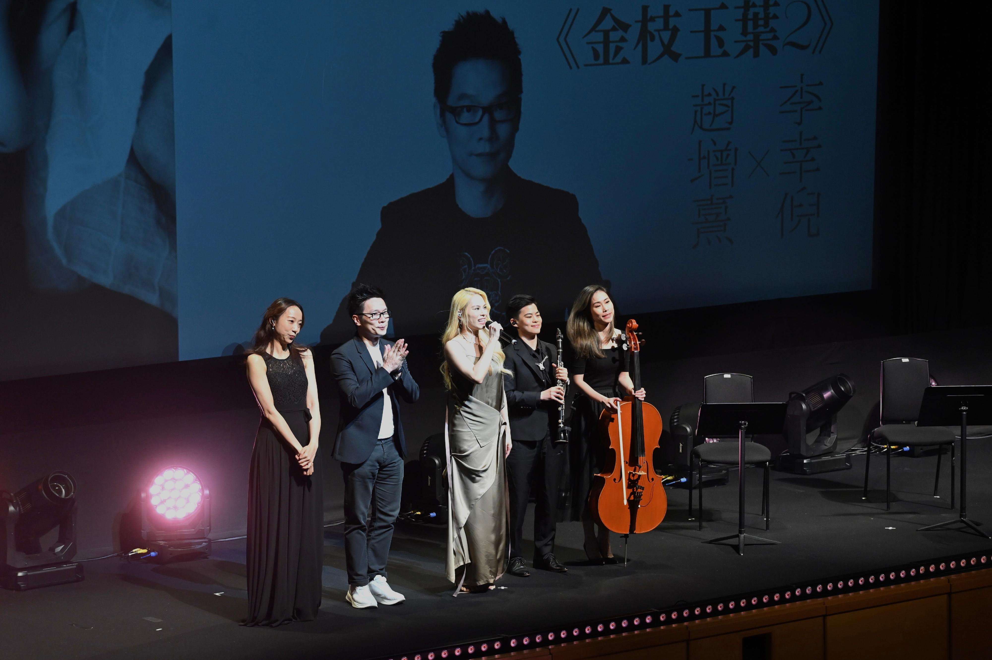 Organised by the Leisure and Cultural Services Department, the opening ceremony of the Hong Kong Pop Culture Festival 2023 was held at the Grand Theatre of the Hong Kong Cultural Centre today (April 22). Photo shows pop singer Gin Lee (centre) and renowned music producer Chiu Tsang-hei (second left) on stage receiving applause after their performance at the opening programme of the Hong Kong Pop Culture Festival 2023.