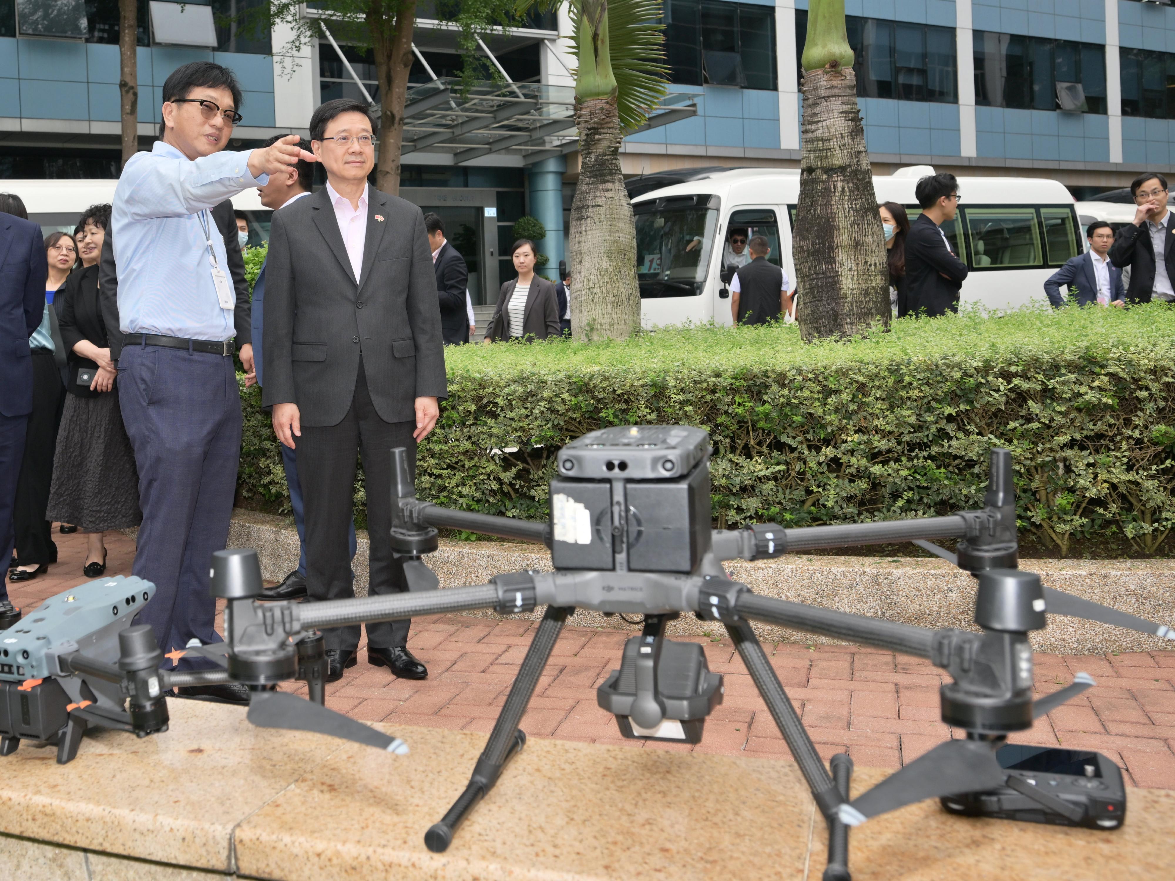 The Chief Executive, Mr John Lee, led a delegation of the Hong Kong Special Administrative Region Government and the Legislative Council (LegCo) to visit Shenzhen today (April 22). Photo shows Mr Lee (right), visiting the SZ DJI Technology Company Limited.
