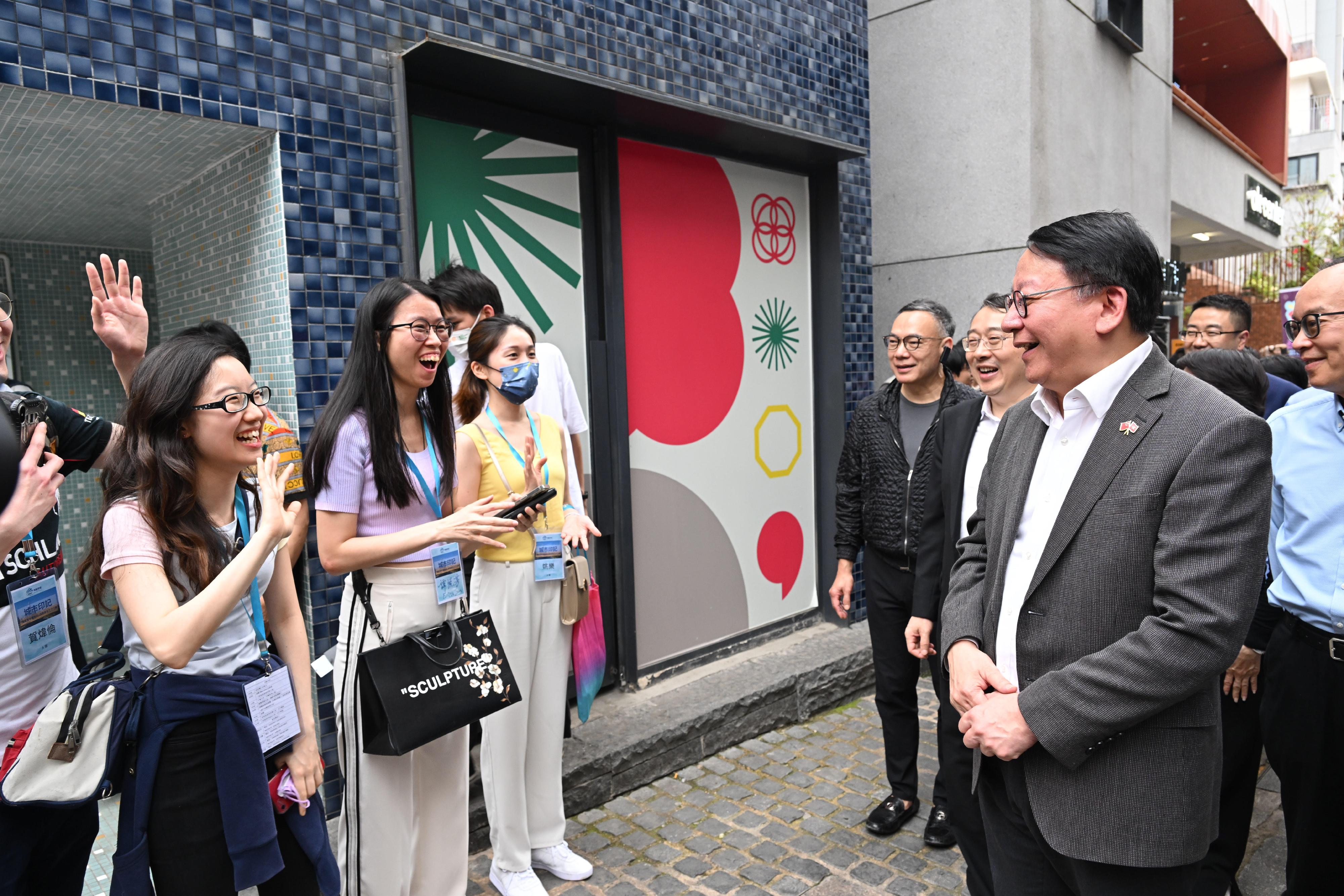The Chief Executive, Mr John Lee, led a delegation of the Hong Kong Special Administrative Region Government and the Legislative Council to visit Shenzhen today (April 22). Photo shows  the Chief Secretary for Administration, Mr Chan Kwok-ki (first right), chatting with the Hong Kong young people at Nantou Ancient Town.