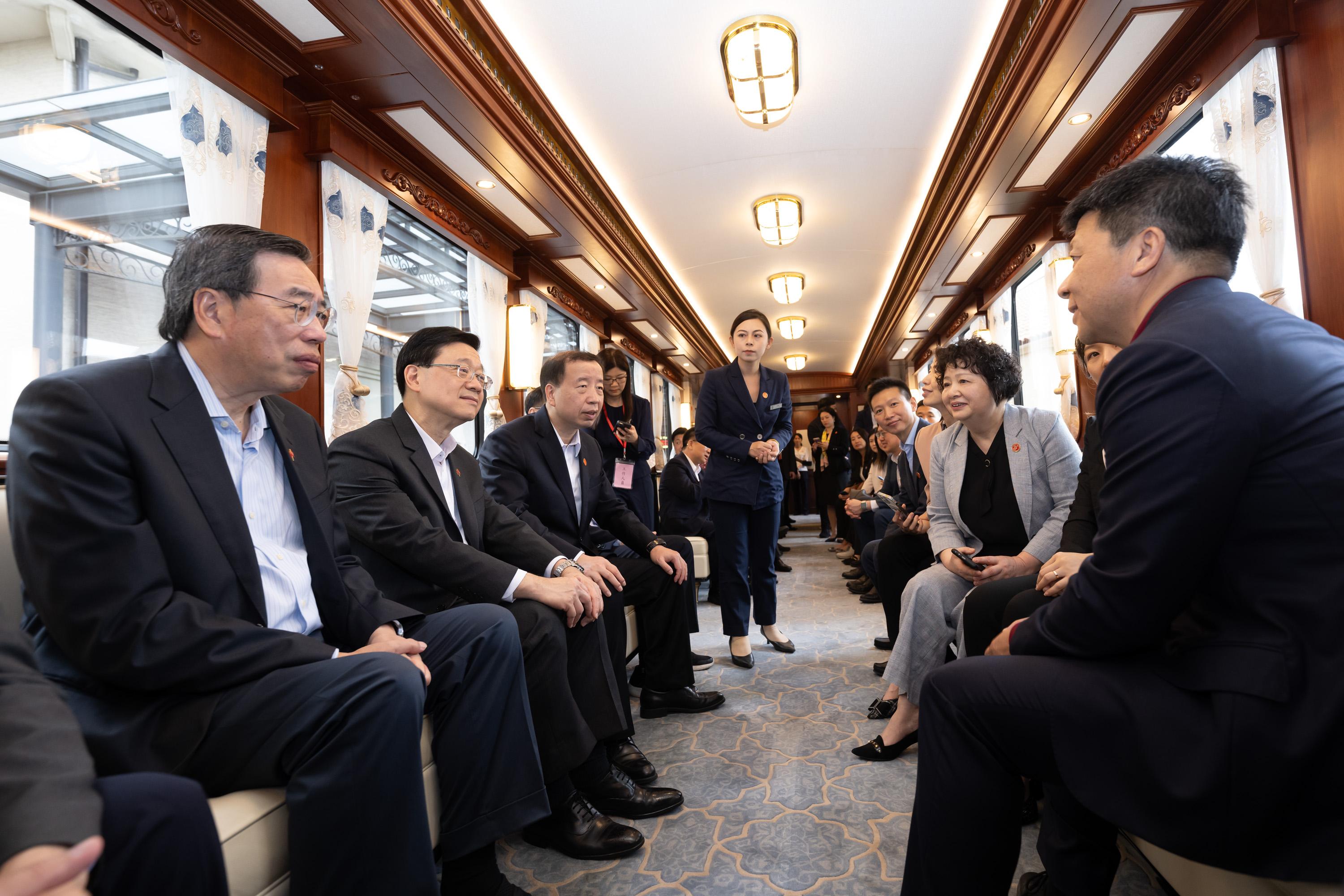 The delegation of the Hong Kong Special Administrative Region Government and the Legislative Council (LegCo) led by the Chief Executive, Mr John Lee, continues its duty visit in the Guangdong-Hong Kong-Macao Greater Bay Area today (April 23). Photo shows the Chief Executive, Mr John Lee (second left); the President of LegCo, Mr Andrew Leung (first left); the Secretary of the Dongguan Municipal Committee of the Communist Party of China, Mr Xiao Yafei (third left); and other delegation members taking a tram to tour the Huawei Ox Horn Campus.