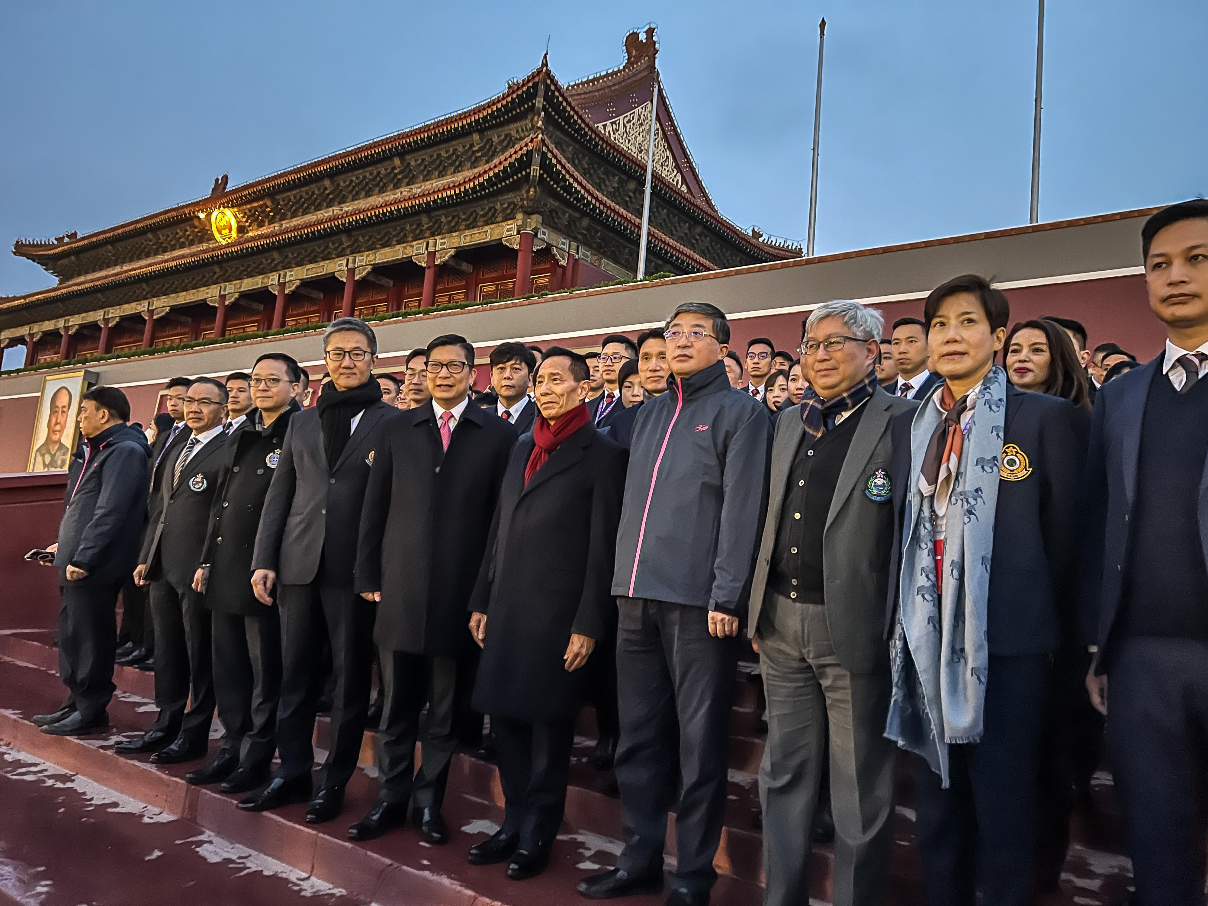 The Secretary for Security, Mr Tang Ping-keung, continued the second day of his visit to Beijing today (April 25). Photo shows Mr Tang (front row, fifth left), together with the heads of disciplined services departments and the Hong Kong Disciplined Services Cultural Exchange Delegation which is currently on an exchange visit on the Mainland, watching the flag-raising ceremony at Tiananmen Square in the early morning.