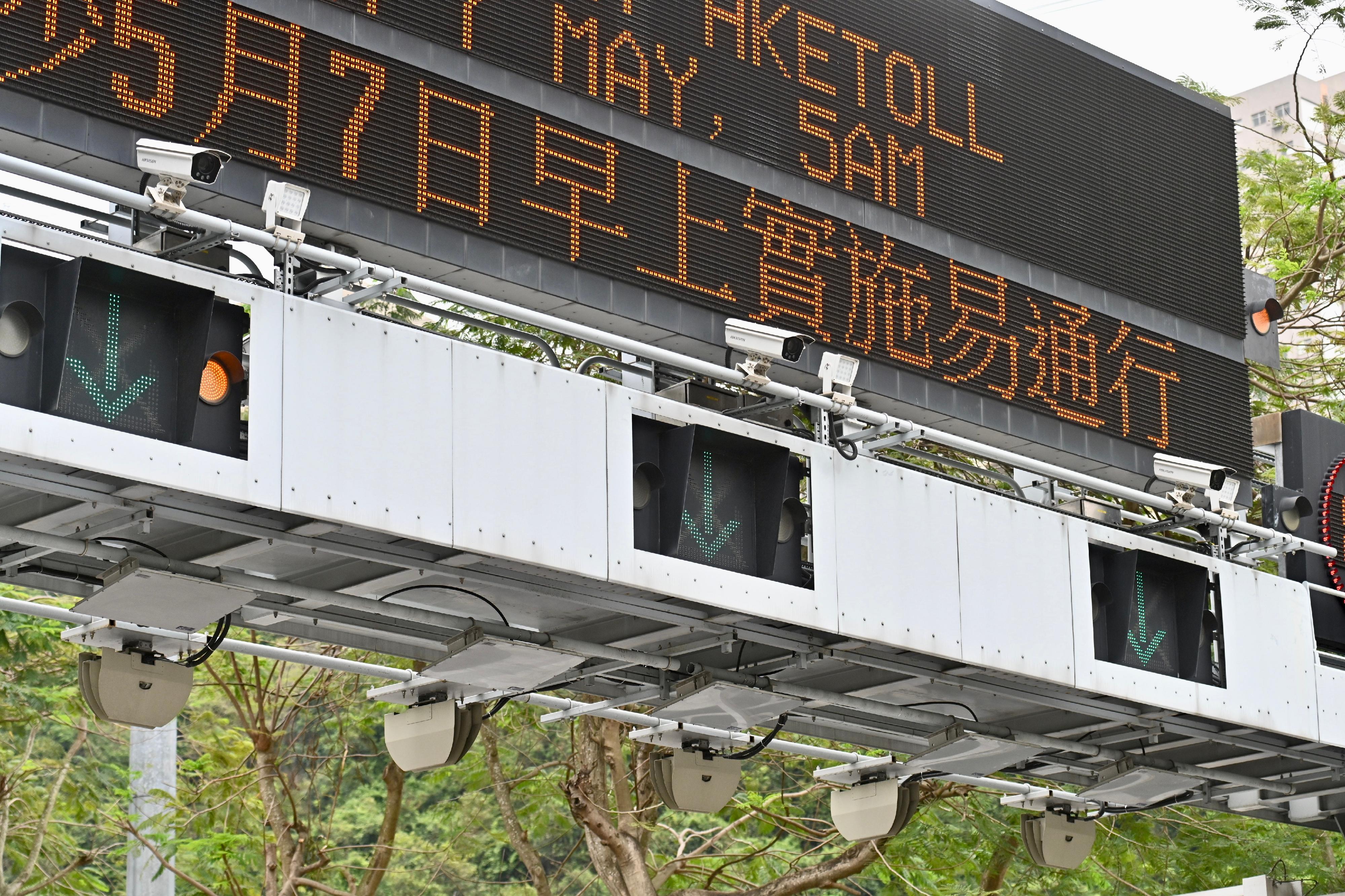 The HKeToll makes use of Radio Frequency Identification (RFID) technology, with the support of automatic number plate recognition technology, to allow vehicles to pay tolls without stopping at toll booths. Photo shows the system in the Tsing Sha Control Area. The use of a tolled tunnel by a motor vehicle will be detected by the field equipment through reading a toll tag affixed on the windscreen of the vehicle or by capturing the image of the vehicle's number plate, and recognising the vehicle registration mark automatically. Tunnel tolls will be deducted from the pre-set toll payment account in the system, and the user will be notified.