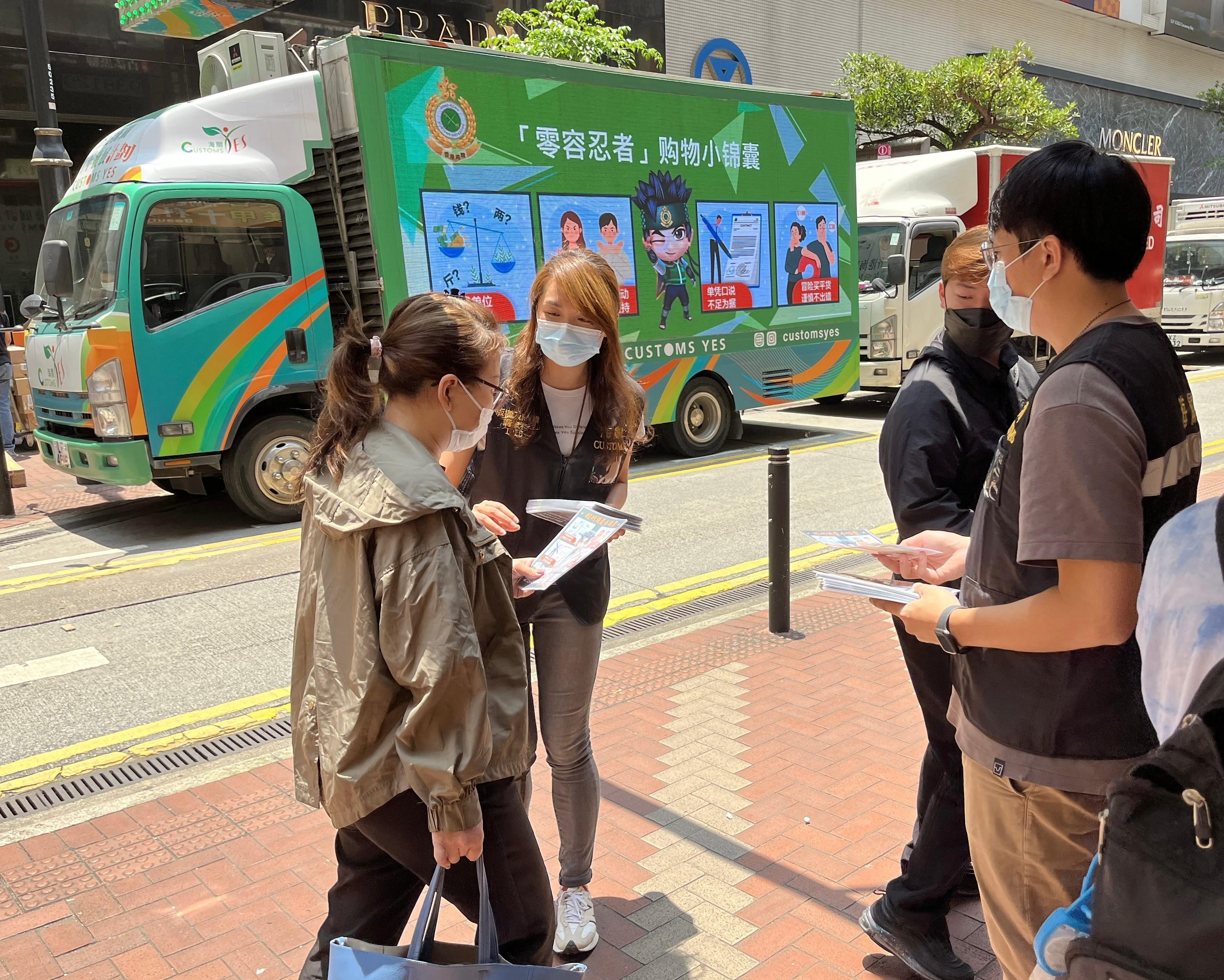 Hong Kong Customs launched an operation codenamed "Felicity" today (April 28) to step up patrols during the Labour Day Golden Week period at popular shopping spots in various districts and to remind traders to comply with the requirements of the Trade Descriptions Ordinance, with a view to safeguarding rights of local consumers and visitors. Photo shows Customs officers distributing pamphlets in Causeway Bay.
