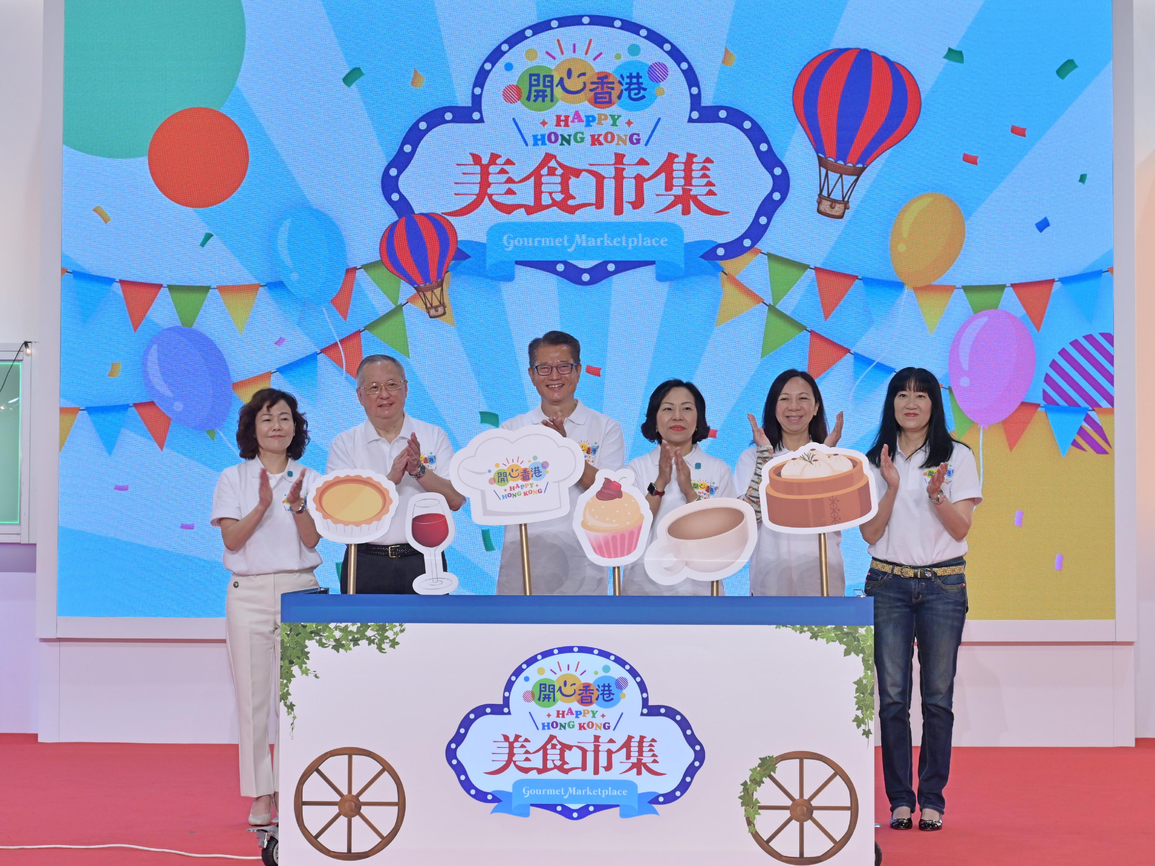 The Financial Secretary, Mr Paul Chan, officiated at the opening ceremony of the first "Happy Hong Kong" Gourmet Marketplace today (April 29). Photo shows (from left) the Director of Home Affairs, Mrs Alice Cheung; Non-official Member of the Executive Council, Legislative Council Member (Catering), Mr Tommy Cheung; Mr Chan; the Secretary for Home and Youth Affairs, Miss Alice Mak; the Permanent Secretary for Home and Youth Affairs, Ms Shirley Lam; and the Executive Director of the Hong Kong Trade Development Council, Ms Margaret Fong, officiating at the ceremony.