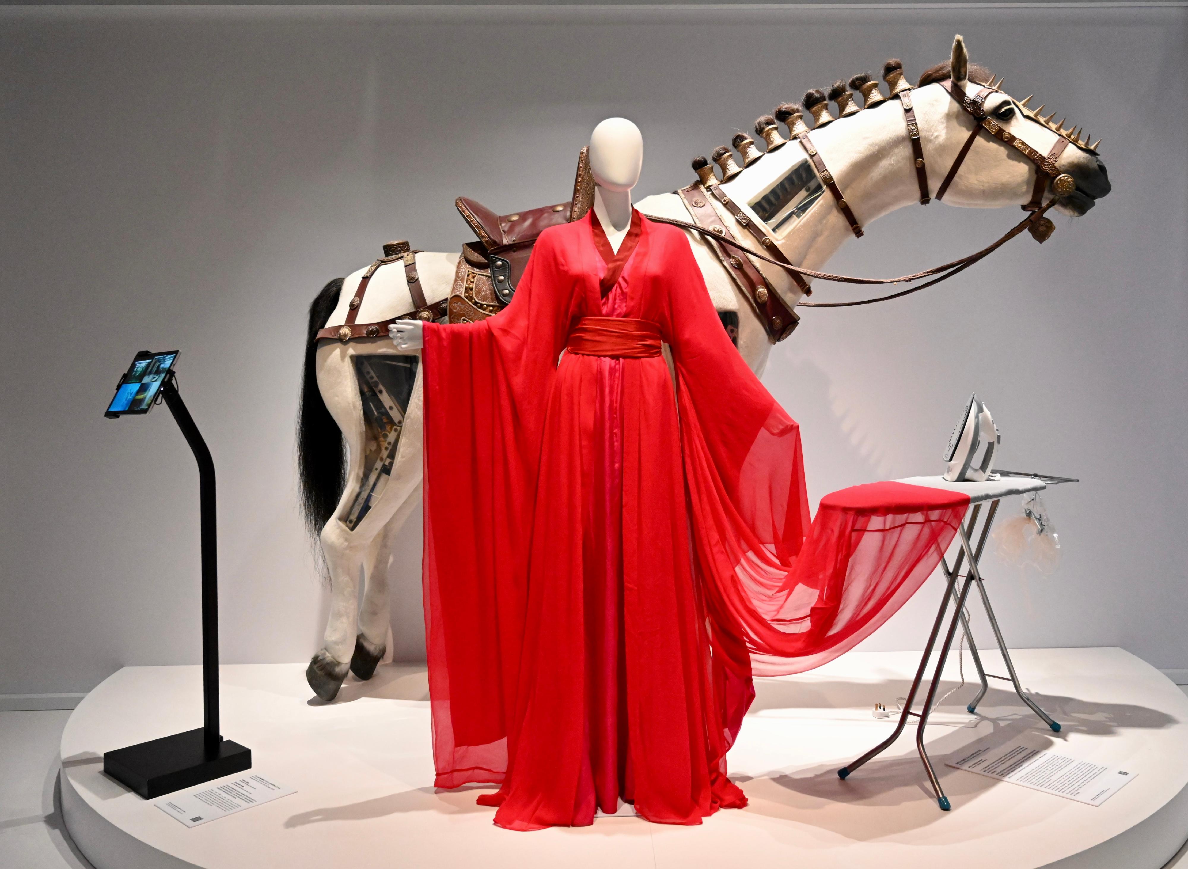 The opening ceremony for the "Out of Thin Air: Hong Kong Film Arts & Costumes Exhibition" was held today (May 2) at the Hong Kong Heritage Museum. Photo shows Maggie Cheung's red period costume from "Hero" (2002) and special prop underwater horse from "Young Detective Dee: Rise of the Sea Dragon" (2013).
