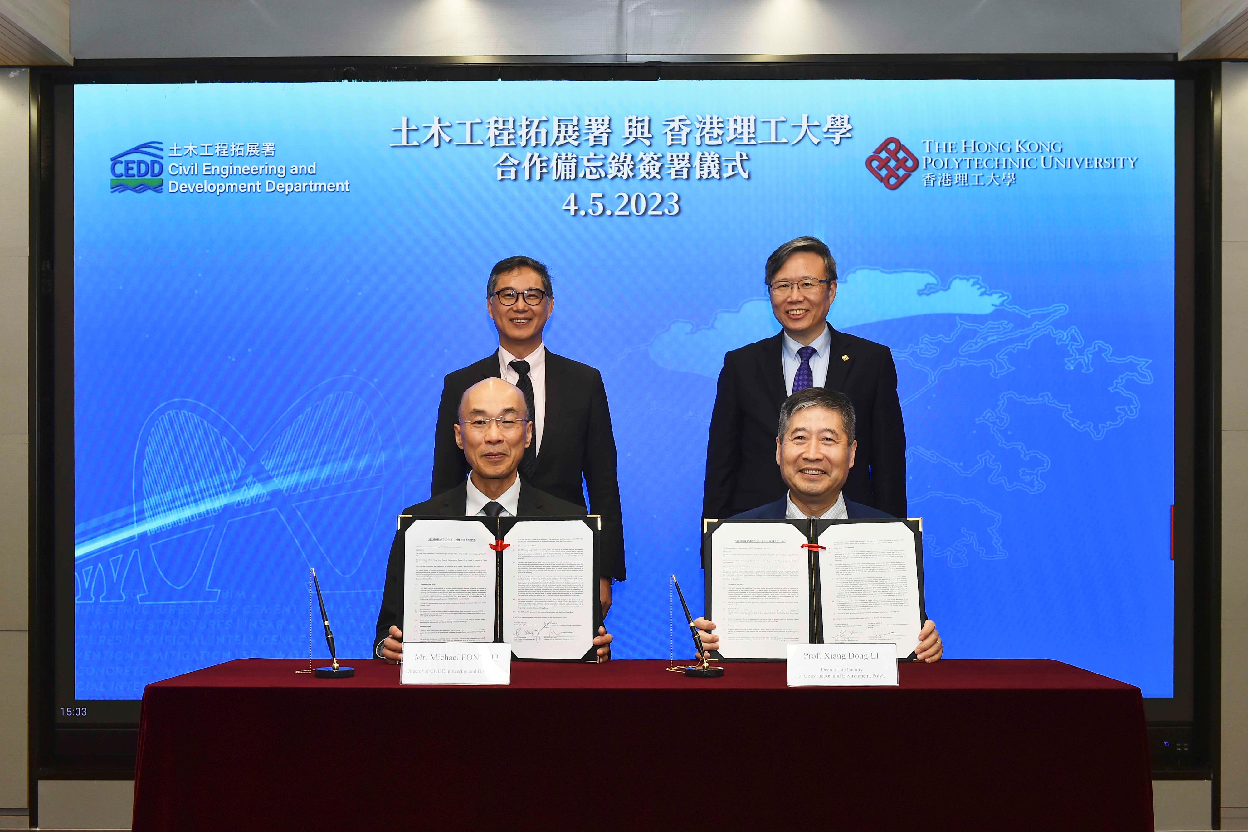 The Civil Engineering and Development Department and The Hong Kong Polytechnic University (PolyU) signed a Memorandum of Understanding (MoU) on research studies for sustainable infrastructure development and land formation today (May 4). Photo shows the Director of the Civil Engineering and Development, Mr Michael Fong (front row, left), and the Dean of the Faculty of Construction and Environment of PolyU, Professor Li Xiangdong (front row, right), signing the MoU as witnessed by the Permanent Secretary for Development (Works) of the Development Bureau, Mr Ricky Lau (back row, left), and the President of PolyU, Professor Teng Jin-Guang (back row, right).
