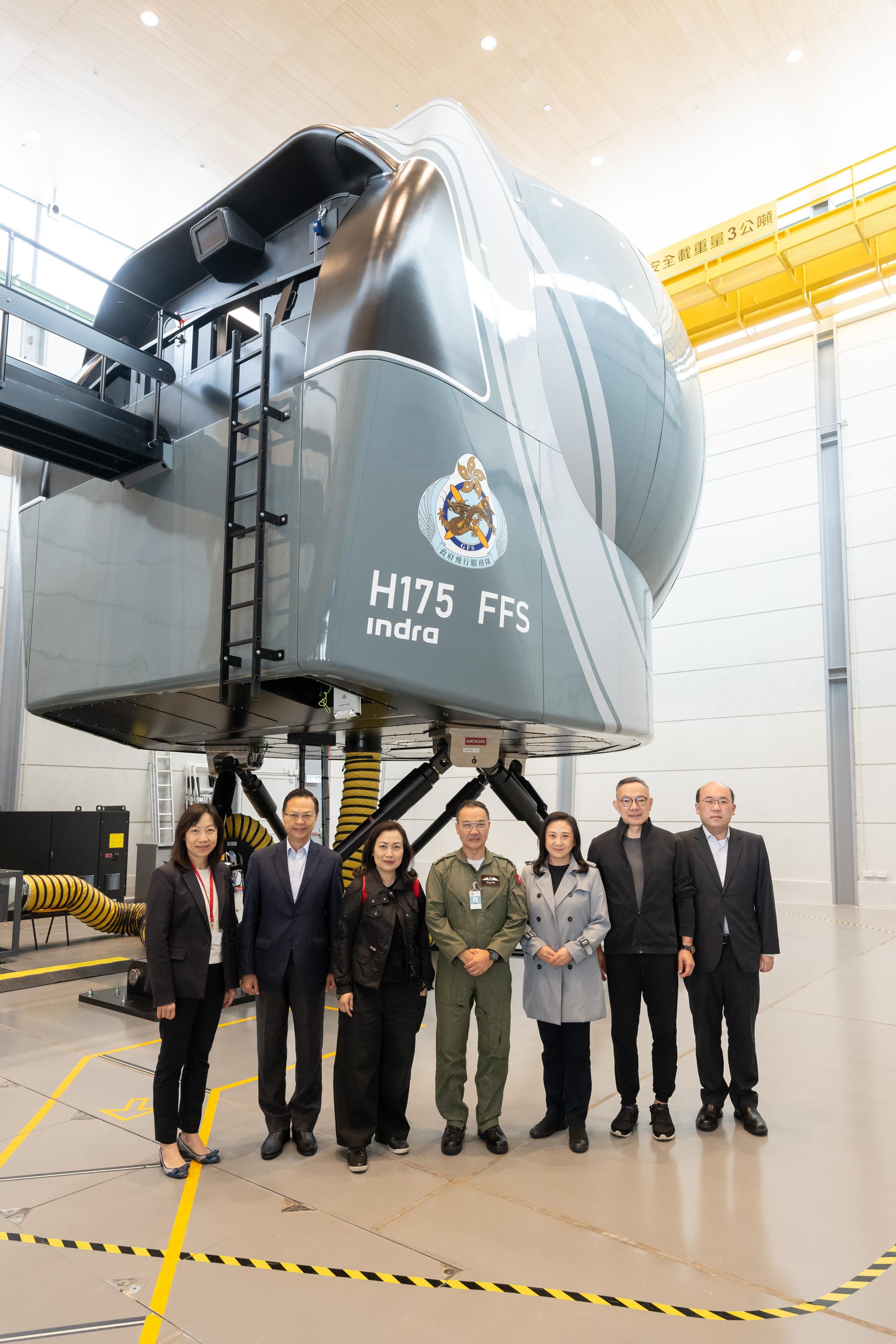 The Legislative Council (LegCo) Panel on Security visited facilities of two disciplined services today (May 9). Photo shows the Deputy Chairman of the Panel, Ms Carmen Kan (third left), the Controller of the Government Flying Service (GFS), Captain West Wu (fourth left), and other LegCo Members posing for a group photo at the Flight Simulator Training Centre in the Headquarters of GFS.