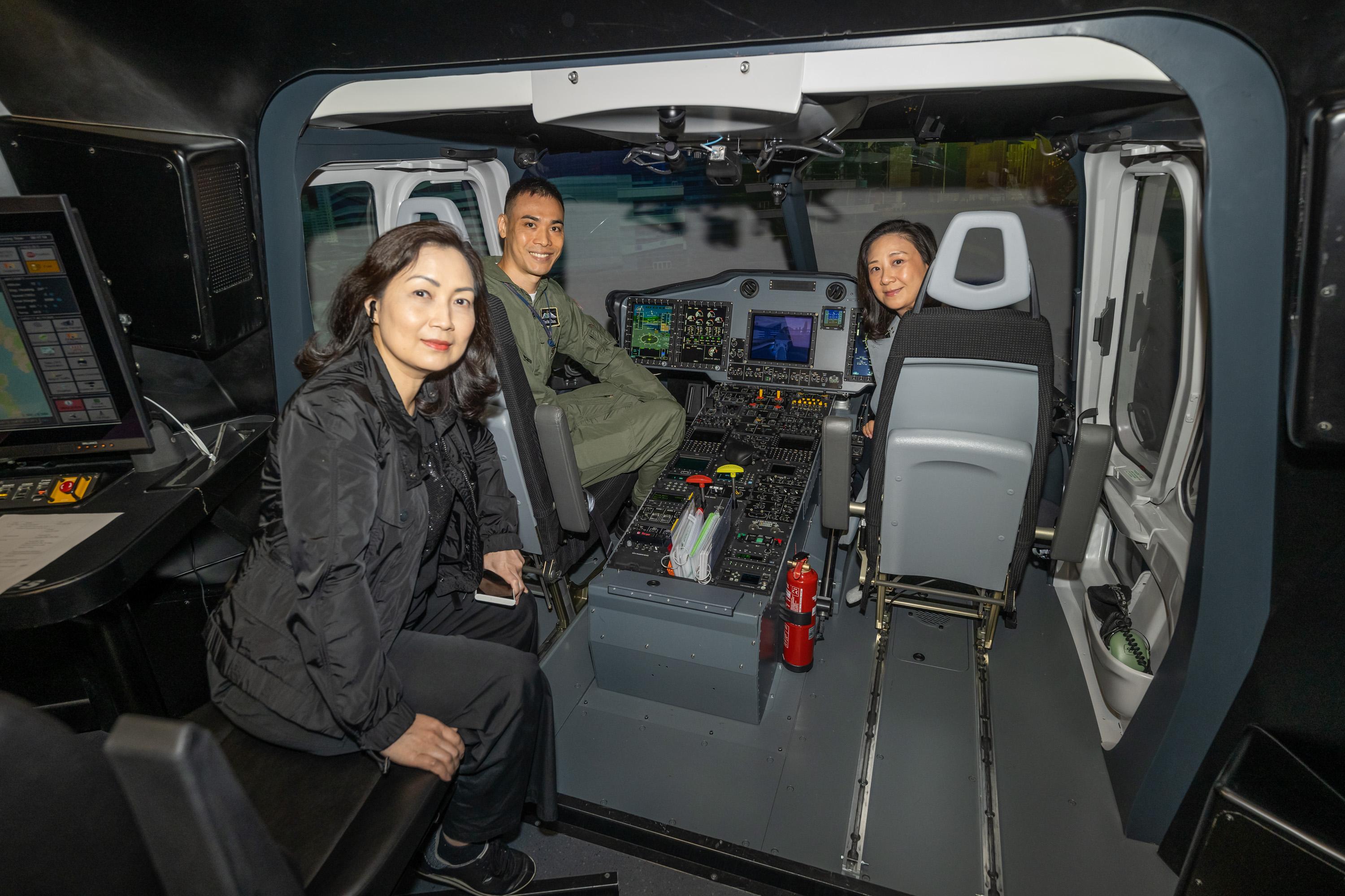 The Legislative Council (LegCo) Panel on Security visited facilities of two disciplined services today (May 9). Photo shows LegCo Members experiencing firsthand the high-fidelity flying conditions in the helicopter flight simulator.