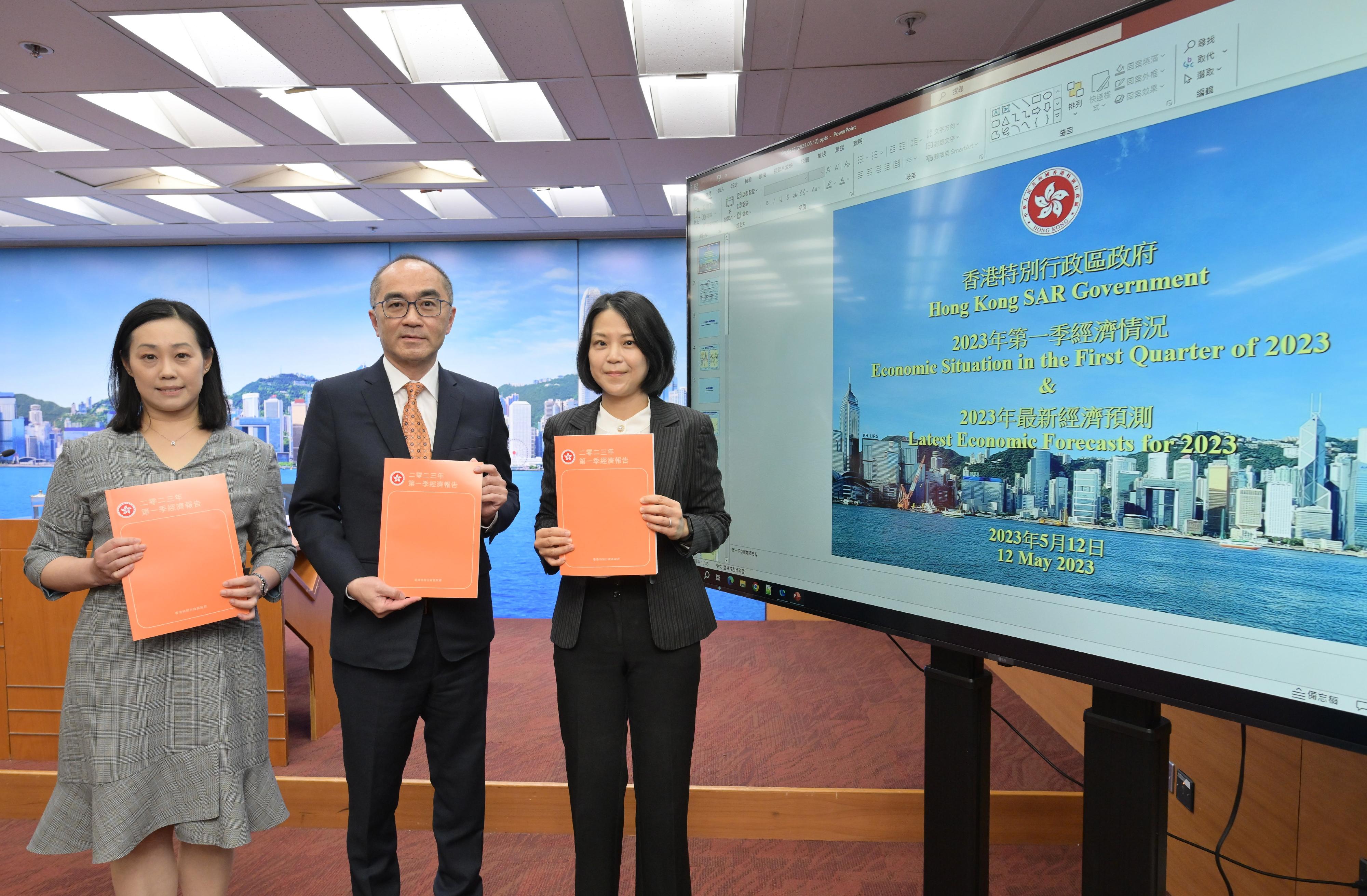 The Government Economist, Mr Adolph Leung (centre), presented the First Quarter Economic Report 2023 at a press conference today (May 12). Also present are Principal Economist Ms Joyce Cheung (left) and Assistant Commissioner for Census and Statistics Ms Edith Chan (right).