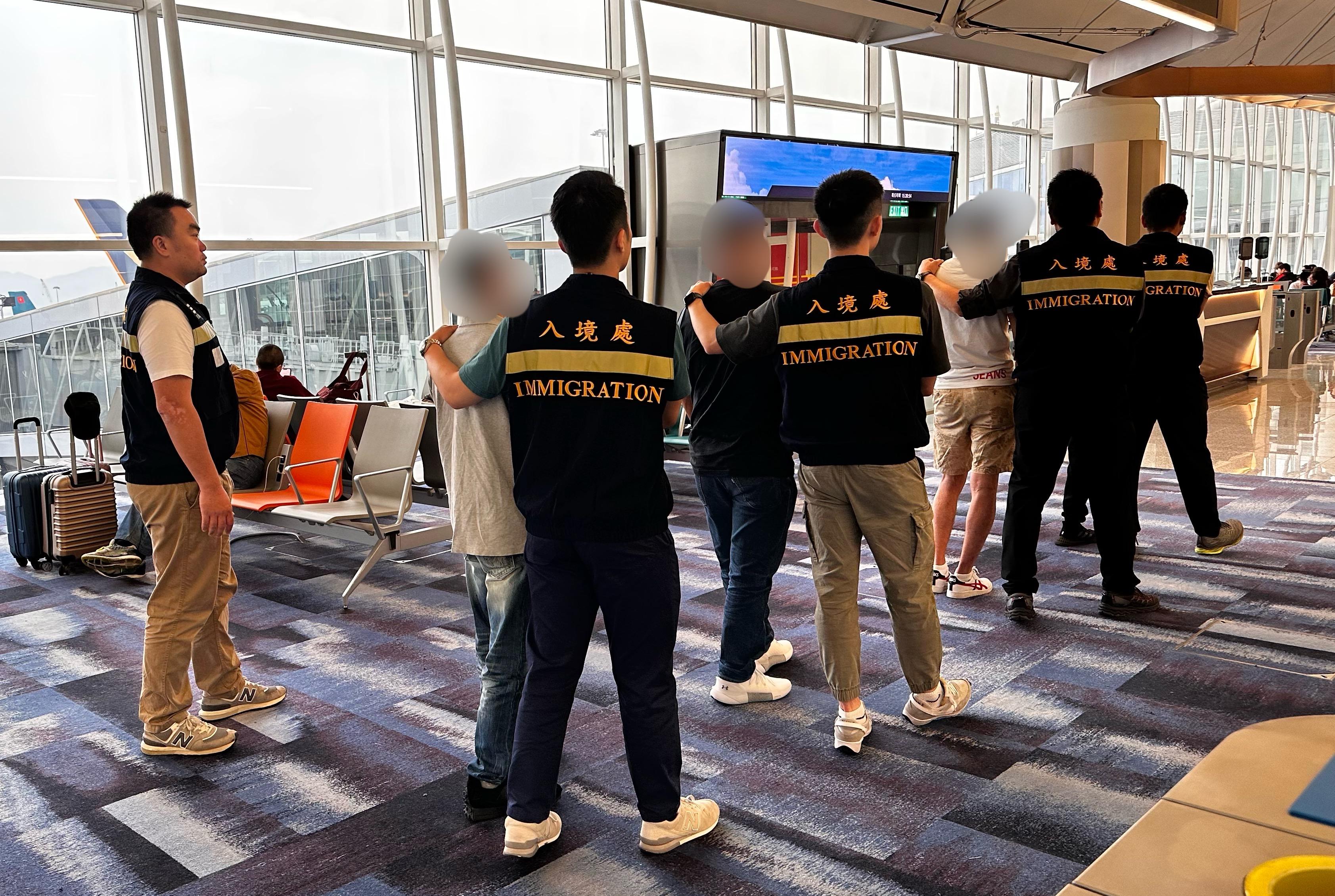 The Immigration Department (ImmD) carried out repatriation operation yesterday (May 12). A total of 23 Vietnamese illegal immigrants were repatriated to Vietnam. Photo shows removees being escorted by ImmD officers to depart Hong Kong.
