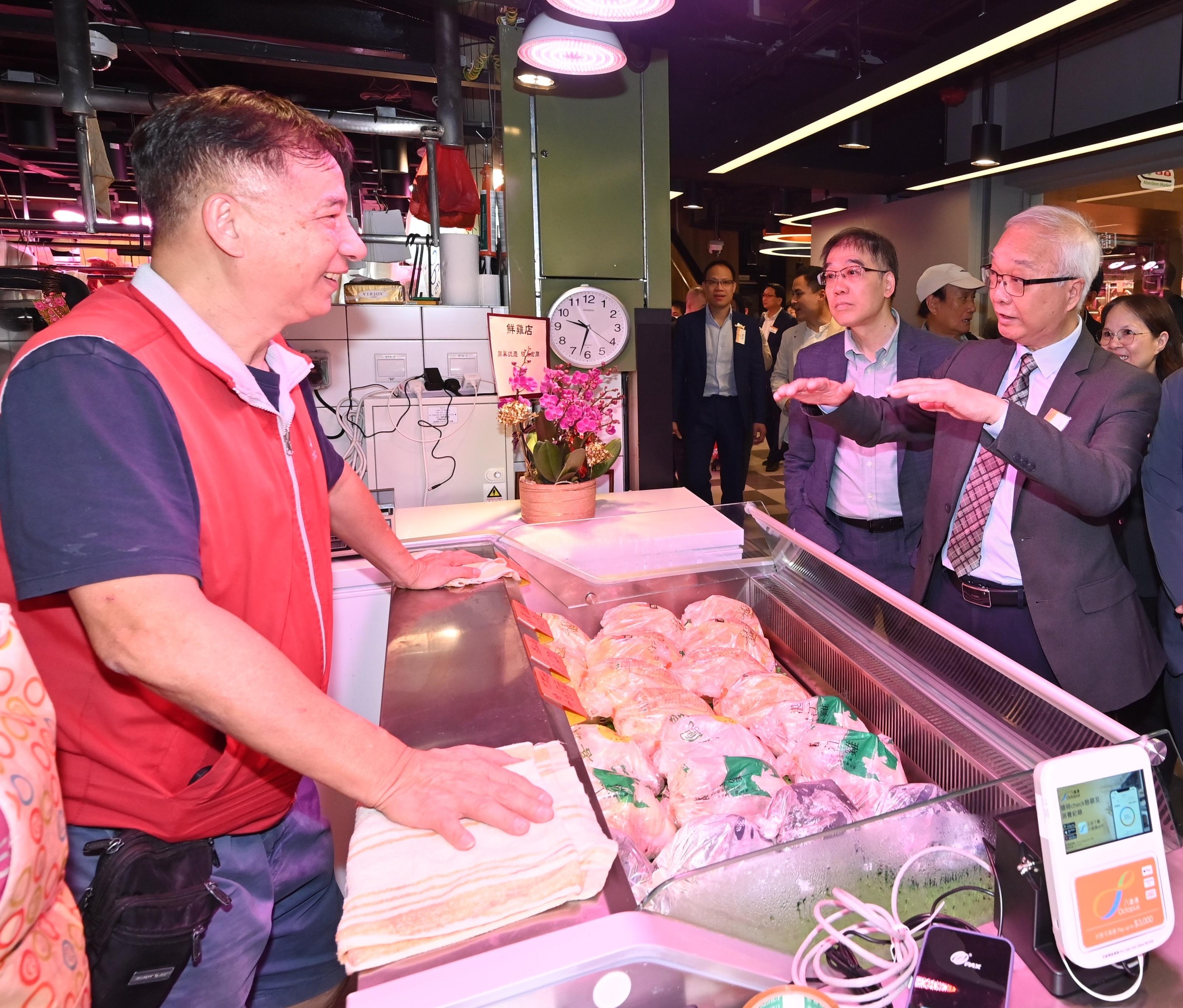The opening ceremony of the overhauled Aberdeen Market under the Food and Environmental Hygiene Department was held today (May 19). Photo shows the Secretary for Environment and Ecology, Mr Tse Chin-wan (first right), chatting with a market stall tenant after officiating at the opening ceremony.
