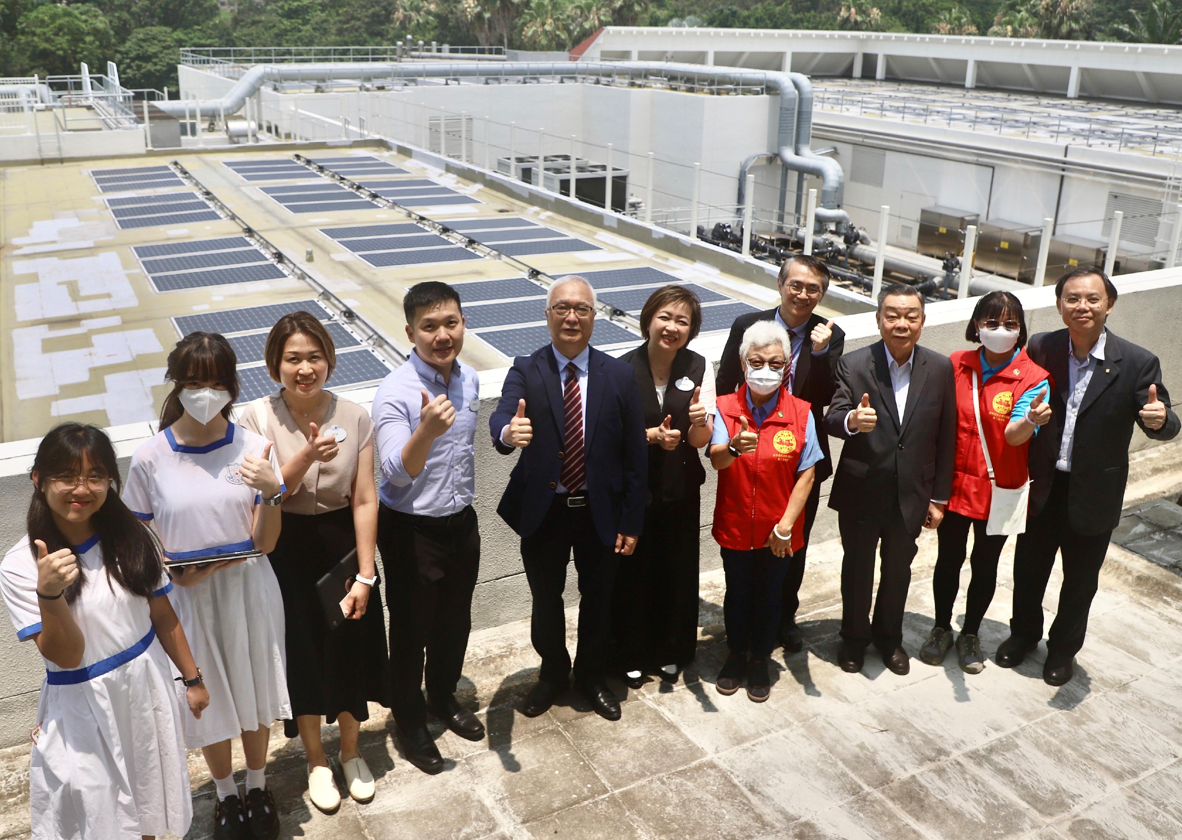 The Secretary for Environment and Ecology, Mr Tse Chin-wan, today (June 2) officiated at the activation ceremony for Hong Kong Disneyland's staff car park solar canopy project at Hong Kong Disneyland Resort. Photo shows Mr Tse (fifth left) and guests visiting various green facilities of Hong Kong Disneyland Hotel, including solar power generation systems and food waste collection facilities.