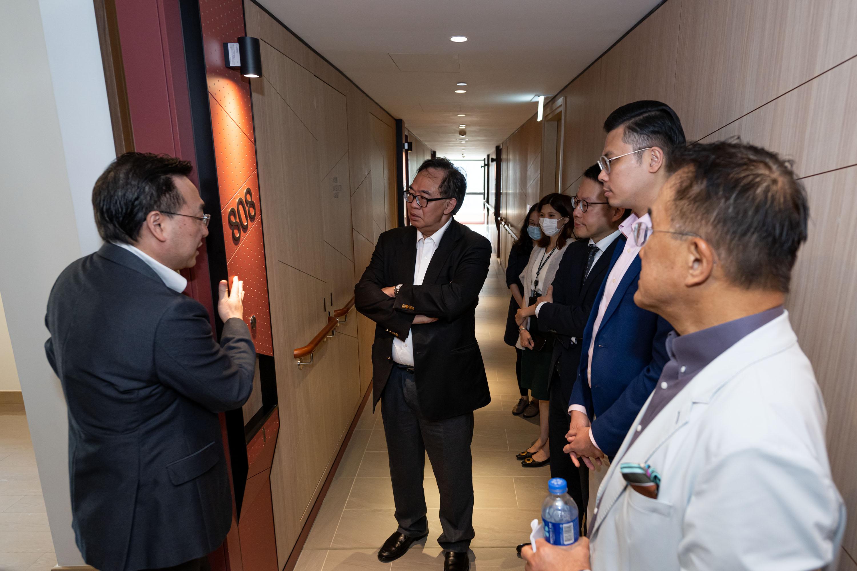 The Legislative Council (LegCo) Panel on Housing visited the Blissful Place of the Hong Kong Housing Society in Hung Hom today (June 2). Photo shows LegCo Members touring the thematic colour design at the residential floor of the Blissful Place.