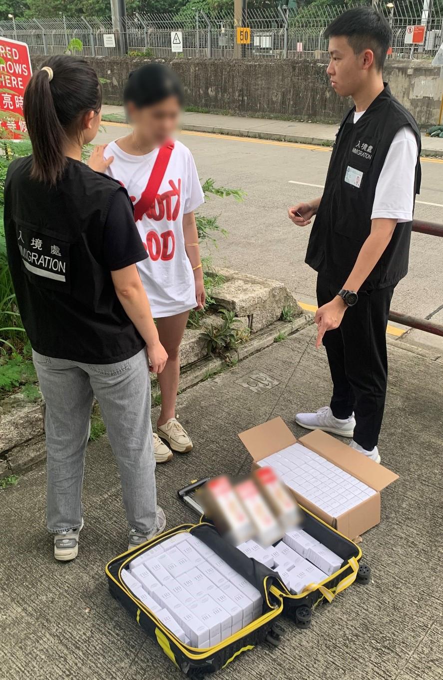 The Immigration Department mounted a series of territory-wide anti-illegal worker operations codenamed "Contribute" and "Twilight", and joint operations with the Hong Kong Police Force codenamed "Champion" and "Windsand", for four consecutive days from June 5 to yesterday (June 8). Photo shows a Mainland visitor involved in suspected parallel trading activities and her goods.