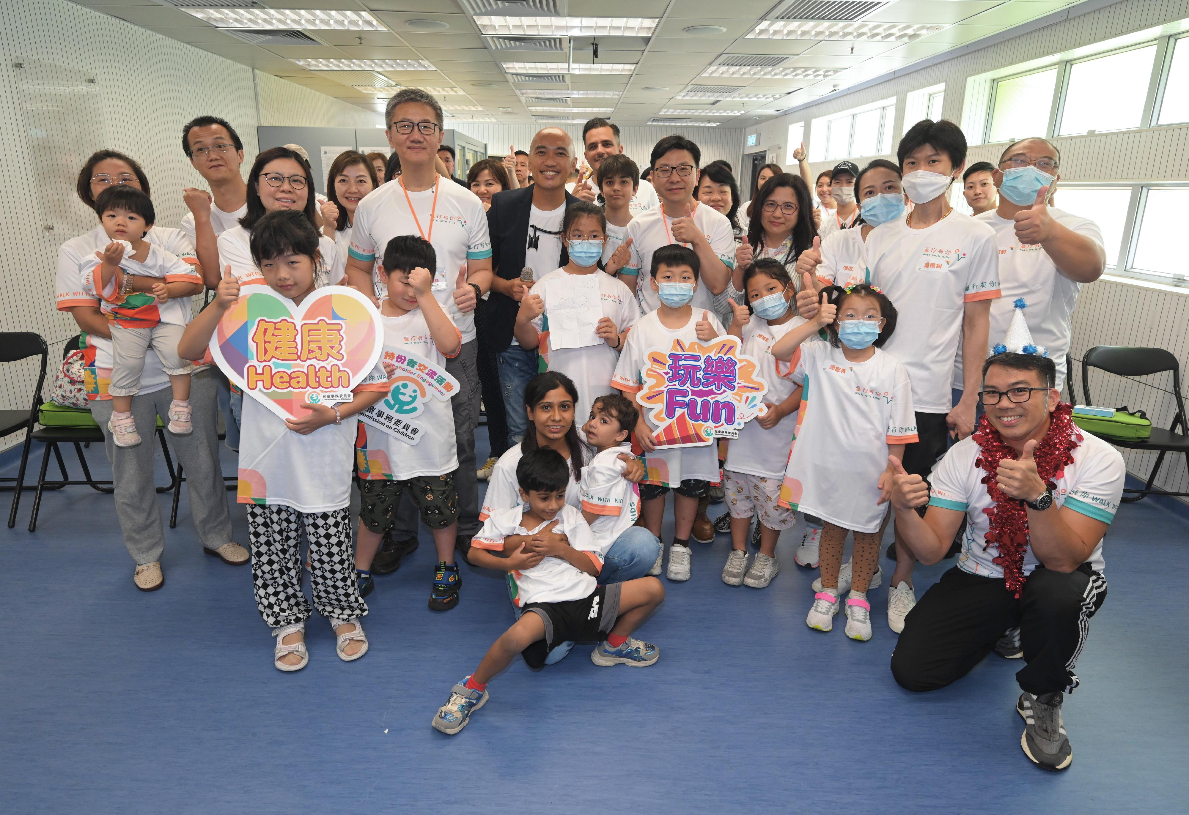 The Commission on Children, the Hong Kong Police Force and the Social Welfare Department today (June 22) jointly held the Walk with Kids@Healthy Happy FUNday at the Junior Police Call Permanent Activity Centre and Integrated Youth Training Camp at Pat Heung. Parents and children joined a variety of interactive games and activities, thereby enhancing their awareness on the importance of physical and mental health. Photo shows the Commissioner of Police, Mr Siu Chak-yee (second row, third left), the Secretary for Labour and Welfare, Mr Chris Sun (second row, fifth right) and participants.