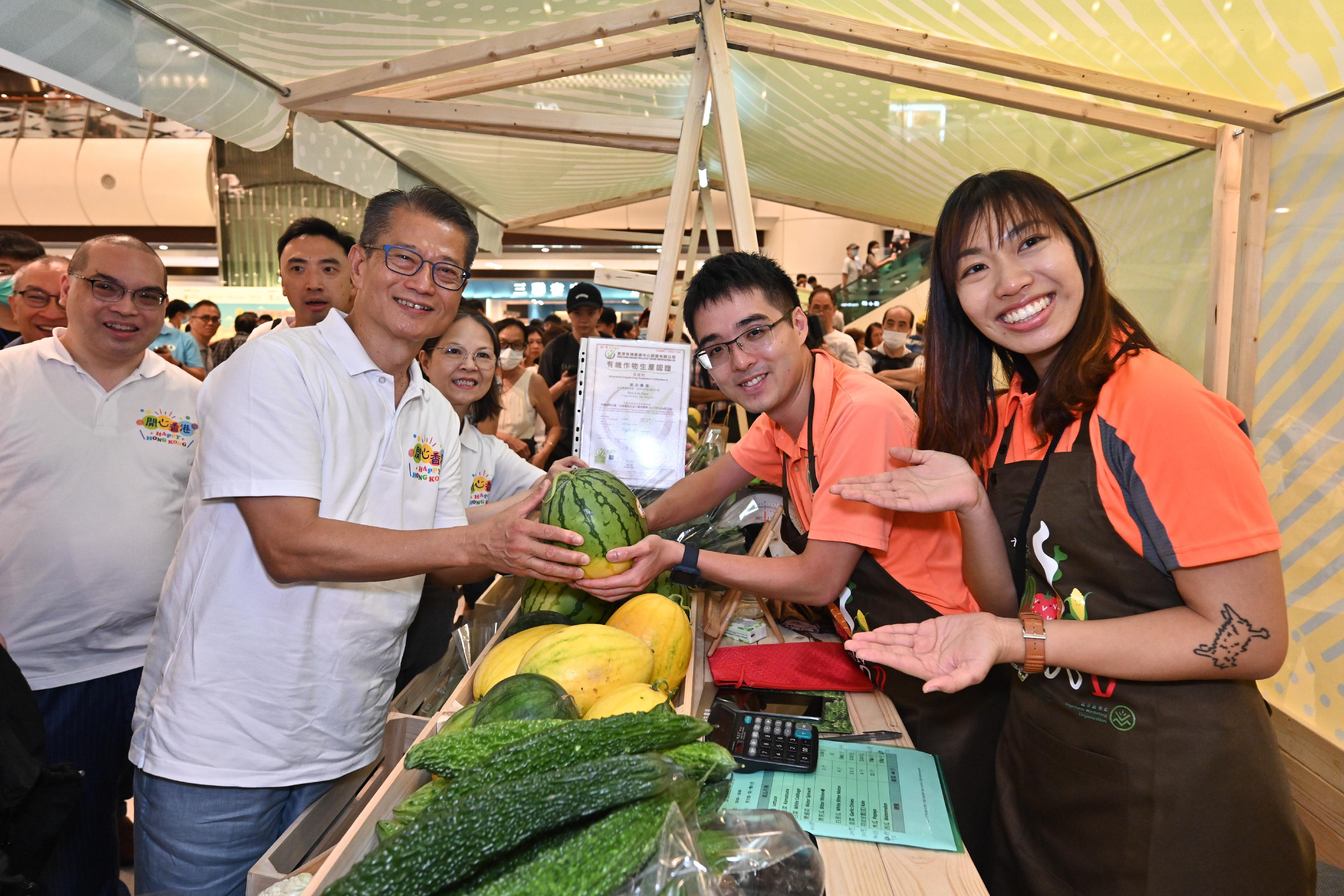 The Financial Secretary, Mr Paul Chan, attended the opening ceremony of the Happy Hong Kong - A and F Carnival: Local Organic Watermelon Festival 2023 today (June 22). Photo shows Mr Chan (fourth right), accompanied by the Under Secretary for Environment and Ecology, Miss Diane Wong (third right), touring the carnival. 