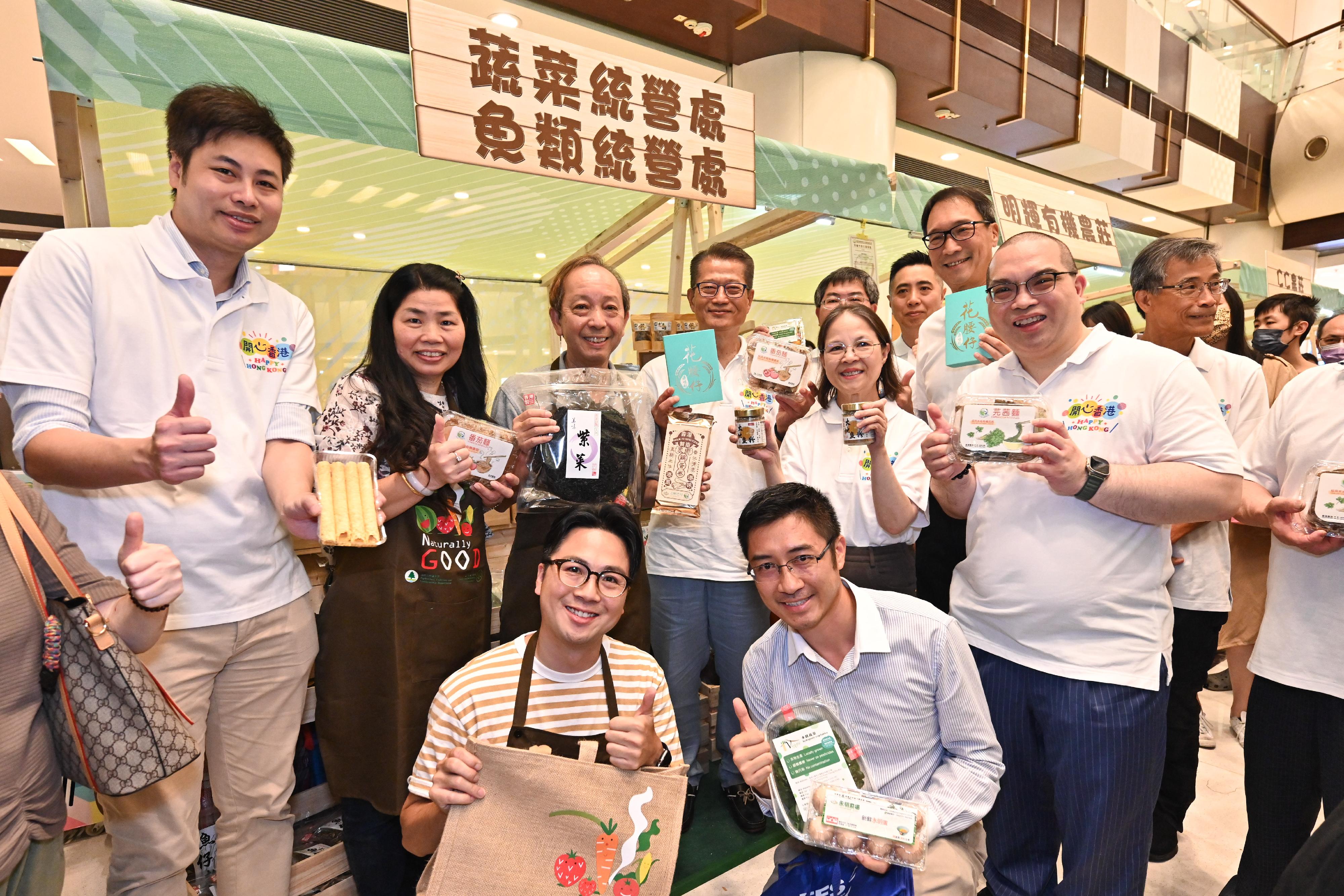 The Financial Secretary, Mr Paul Chan, attended the opening ceremony of the Happy Hong Kong - A and F Carnival: Local Organic Watermelon Festival 2023 today (June 22). Photo shows Mr Chan (second row, third right), accompanied by the Under Secretary for Environment and Ecology, Miss Diane Wong (second row, second right), and the Director of Agriculture, Fisheries and Conservation, Dr Leung Siu-fai (third row, third right), touring the carnival.