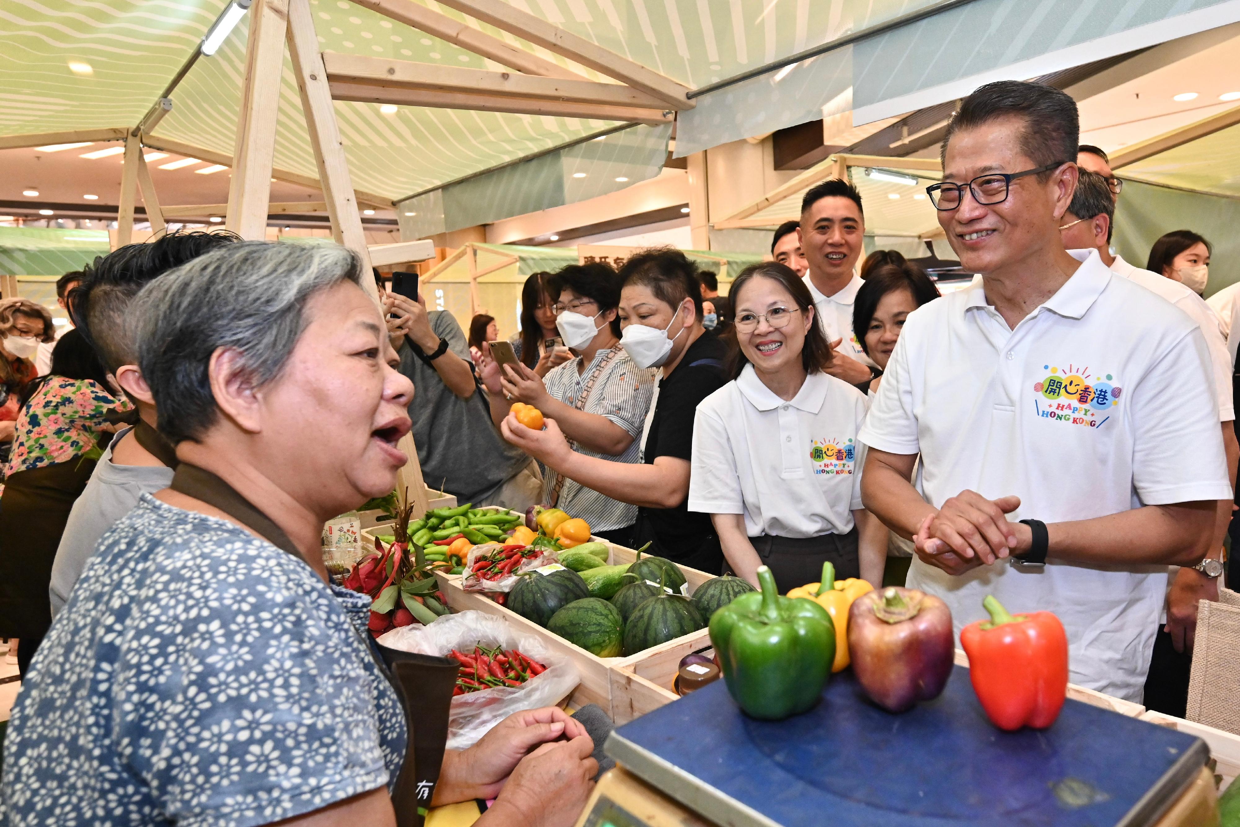 The Financial Secretary, Mr Paul Chan, attended the opening ceremony of the Happy Hong Kong - A and F Carnival: Local Organic Watermelon Festival 2023 today (June 22). Photo shows Mr Chan (first right), accompanied by the Under Secretary for Environment and Ecology, Miss Diane Wong (second right), touring the carnival.