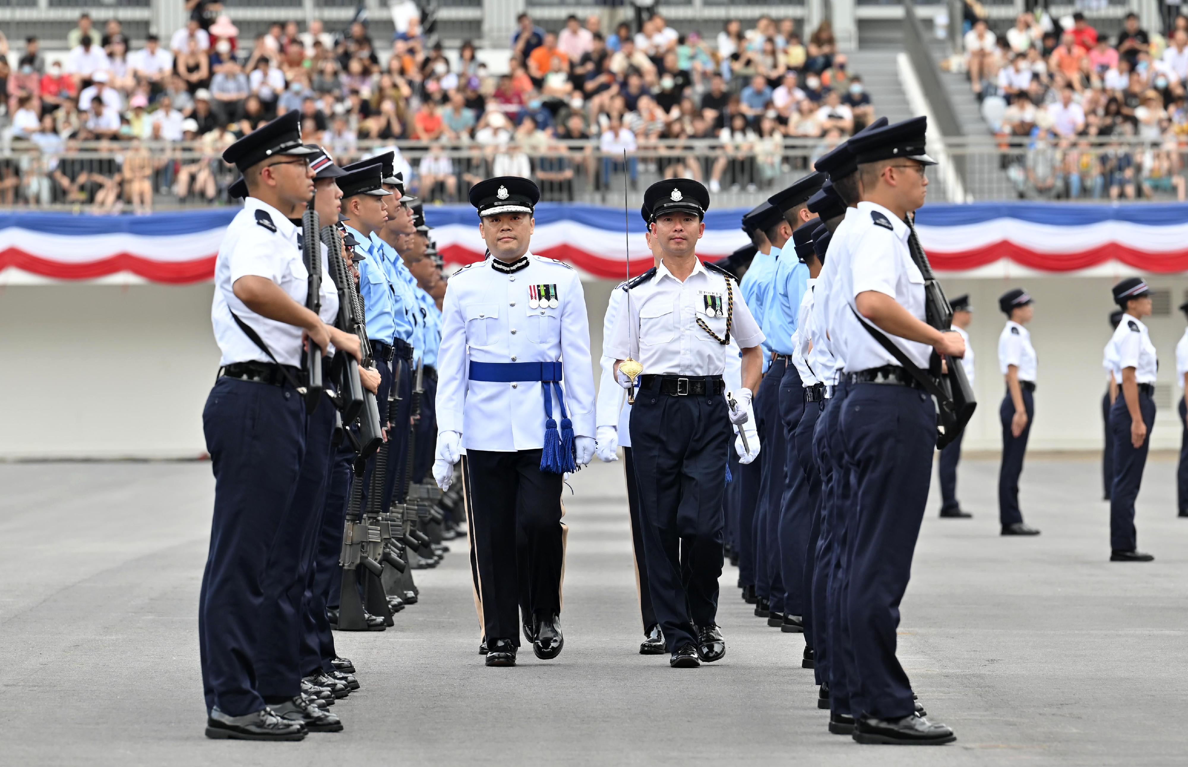 The Deputy Commissioner of Police (Operations), Mr Yuen Yuk-kin, inspects a passing-out parade as a reviewing officer at the Hong Kong Police College today (June 24).