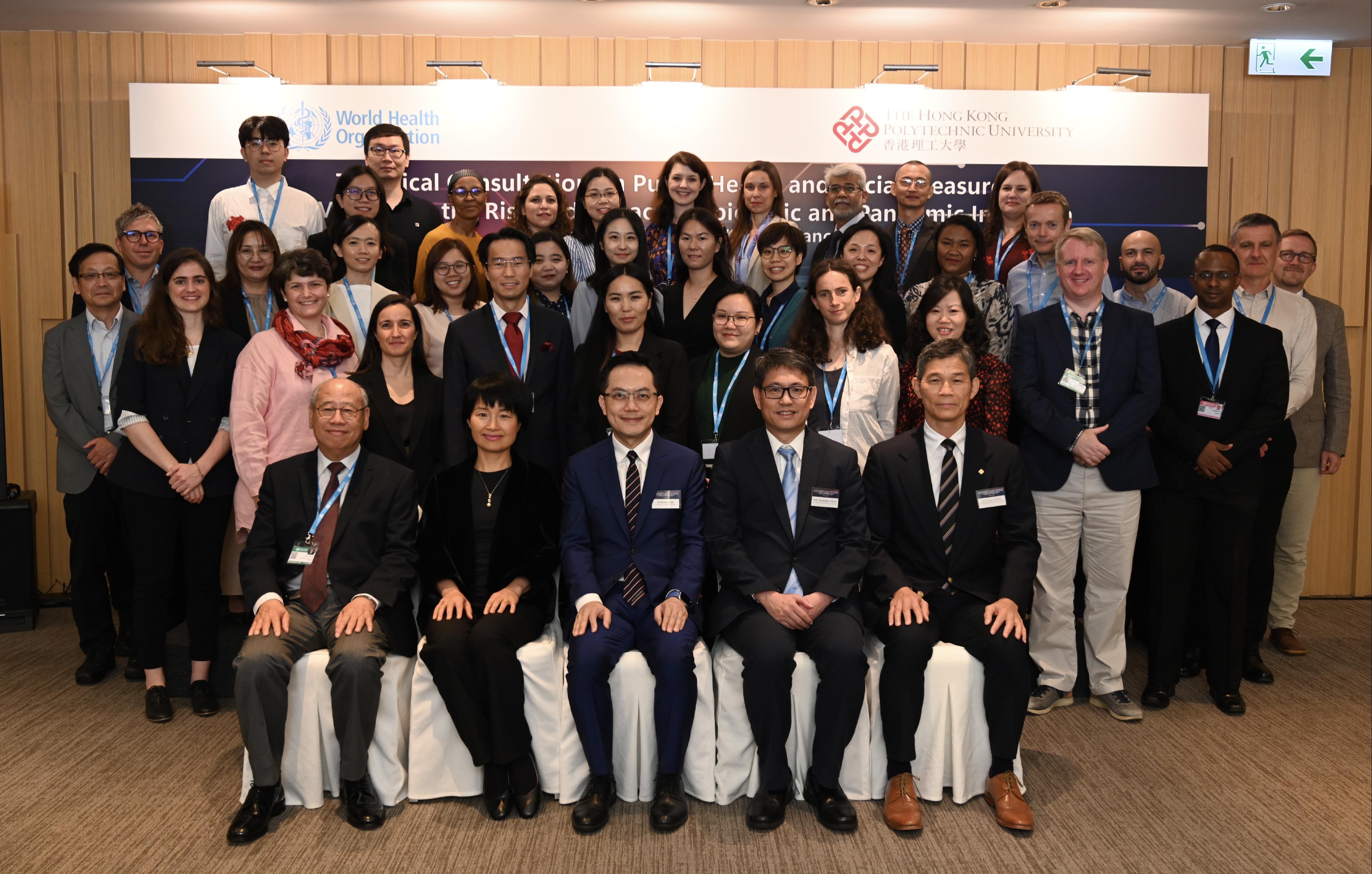 The World Health Organization today (June 27) held a technical consultation on public health and social measures (PHSMs) for mitigating the risk and impact of epidemic and pandemic influenza in Hong Kong. The Director of Health, Dr Ronald Lam, attended the meeting today and delivered his opening remarks, sharing his insights on PHSMs. Photo shows Dr Lam (first row, centre) with other participants.