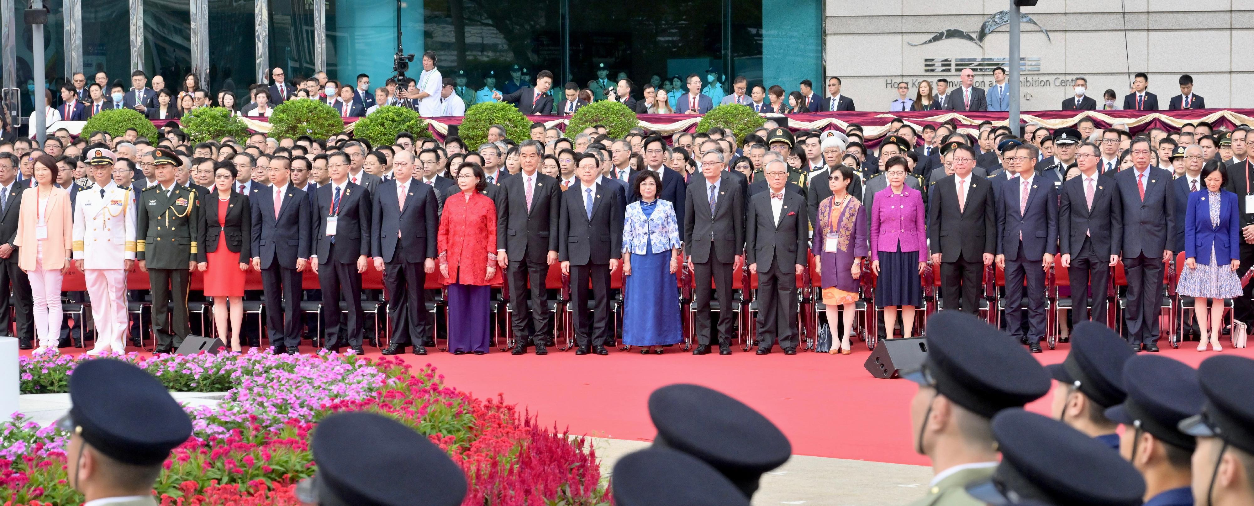 The Chief Executive, Mr John Lee (front row, 10th left), and his wife (front row, 10th right); the Chief Justice of the Court of Final Appeal, Mr Andrew Cheung Kui-nung (front row, 9th right); former CE Mr Donald Tsang (front row, 8th right), and his wife (front row, 7th right); Vice-Chairman of the National Committee of the CPPCC Mr C Y Leung (front row, 9th left), and his wife (front row, 8th right); former CE Mrs Carrie Lam (front row, 6th right); the Director of the LOCPG in the HKSAR, Mr Zheng Yanxiong (front row, 7th left); Deputy Head of the Office for Safeguarding National Security of the CPG in the HKSAR Mr Li Jiangzhou (front row, 6th left); the Commissioner of the Ministry of Foreign Affairs in the HKSAR, Mr Liu Guangyuan (front row, 5th left), and his wife (front row, 4th left); the Commander-in-chief of the CPLA Hong Kong Garrison, Major General Peng Jingtang (front row, 3rd left); the Political Commissar of the CPLA Hong Kong Garrison, Navy Rear Admiral Lai Ruxin (front row, 2nd left); the Chief Secretary for Administration, Mr Chan Kwok-ki (front row, 5th right); the Financial Secretary, Mr Paul Chan (front row, 4th right); the Secretary for Justice, Mr Paul Lam, SC (front row, 3rd right); the President of the LC, Mr Andrew Leung (front row, 2nd right); the Convenor of the Non-official Members of the ExCo, Mrs Regina Ip (front row, 1st right), together with Principal Officials and guests, attend the flag-raising ceremony for the 26th anniversary of the establishment of the HKSAR at Golden Bauhinia Square in Wan Chai this morning (July 1).