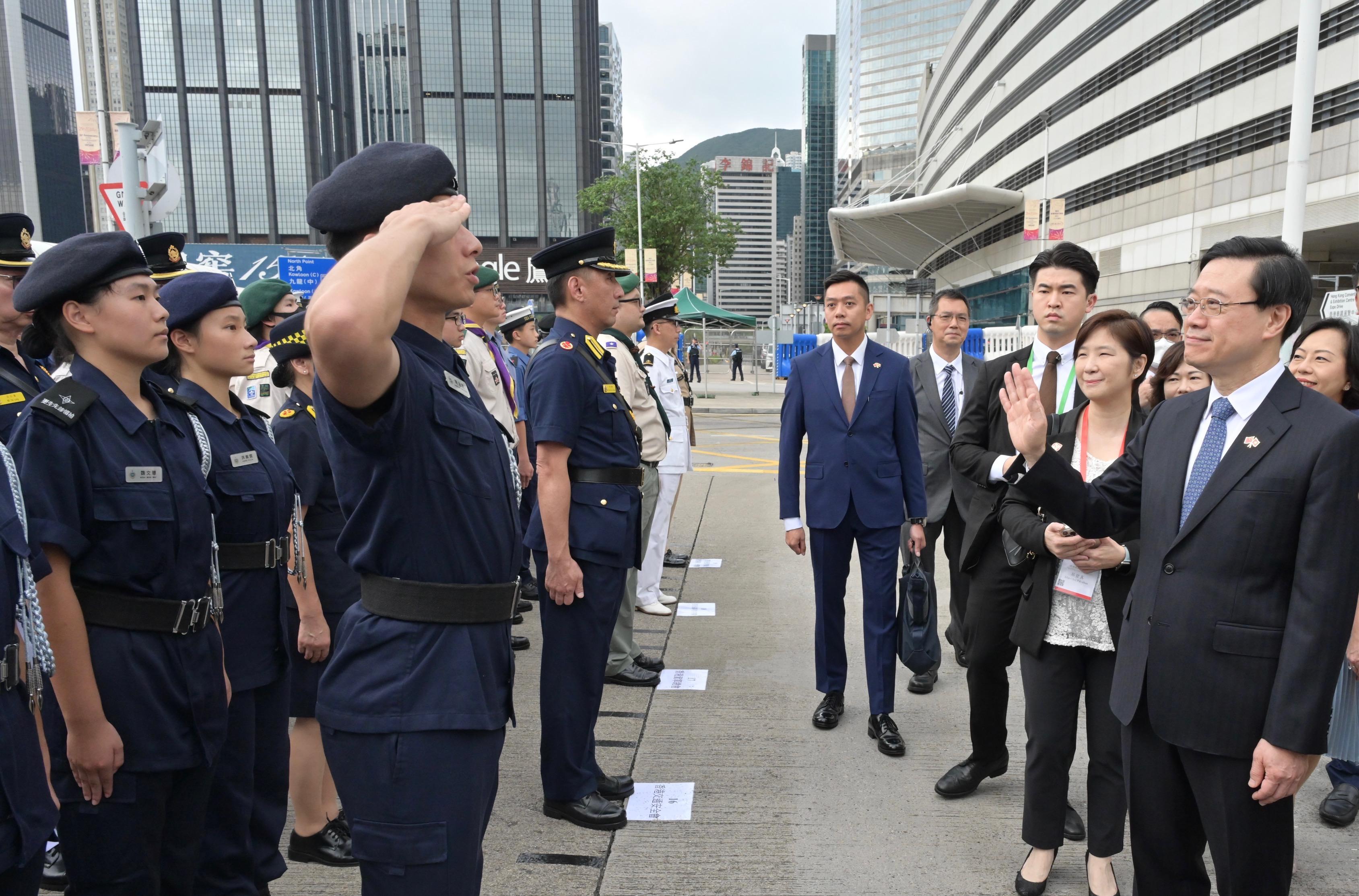 The Chief Executive, Mr John Lee, together with Principal Officials and guests, attends the flag-raising ceremony for the 26th anniversary of the establishment of the Hong Kong Special Administrative Region at Golden Bauhinia Square in Wan Chai this morning (July 1). Photo shows Mr Lee (first right) receiving salute by uniformed groups.