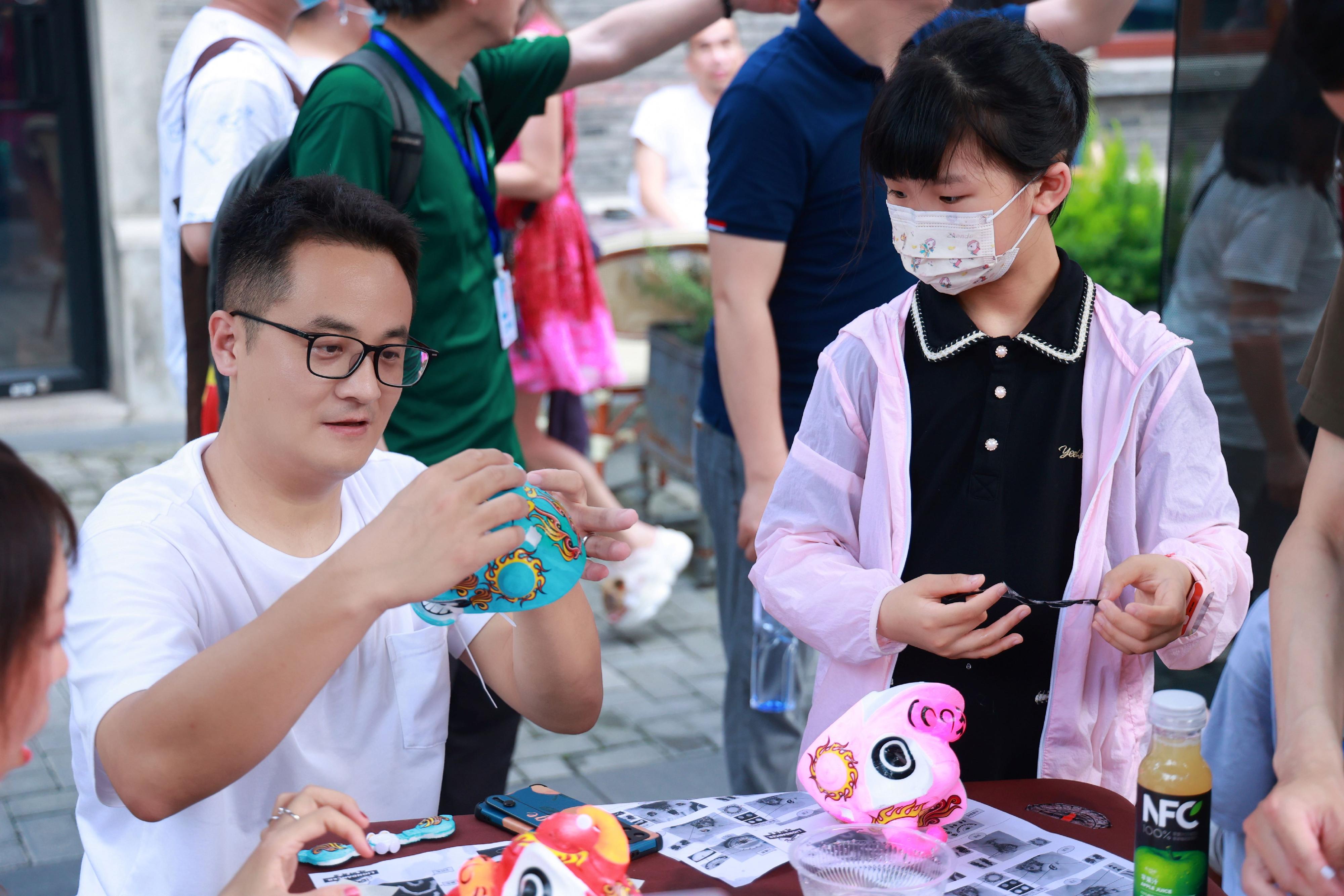 To celebrate the 26th anniversary of Hong Kong's return to the motherland, the Hong Kong Economic and Trade Office in Shanghai unveiled a series of celebratory events today (July 1) in Shanghai. Photo shows citizens participating in a workshop on lion dance head-making.