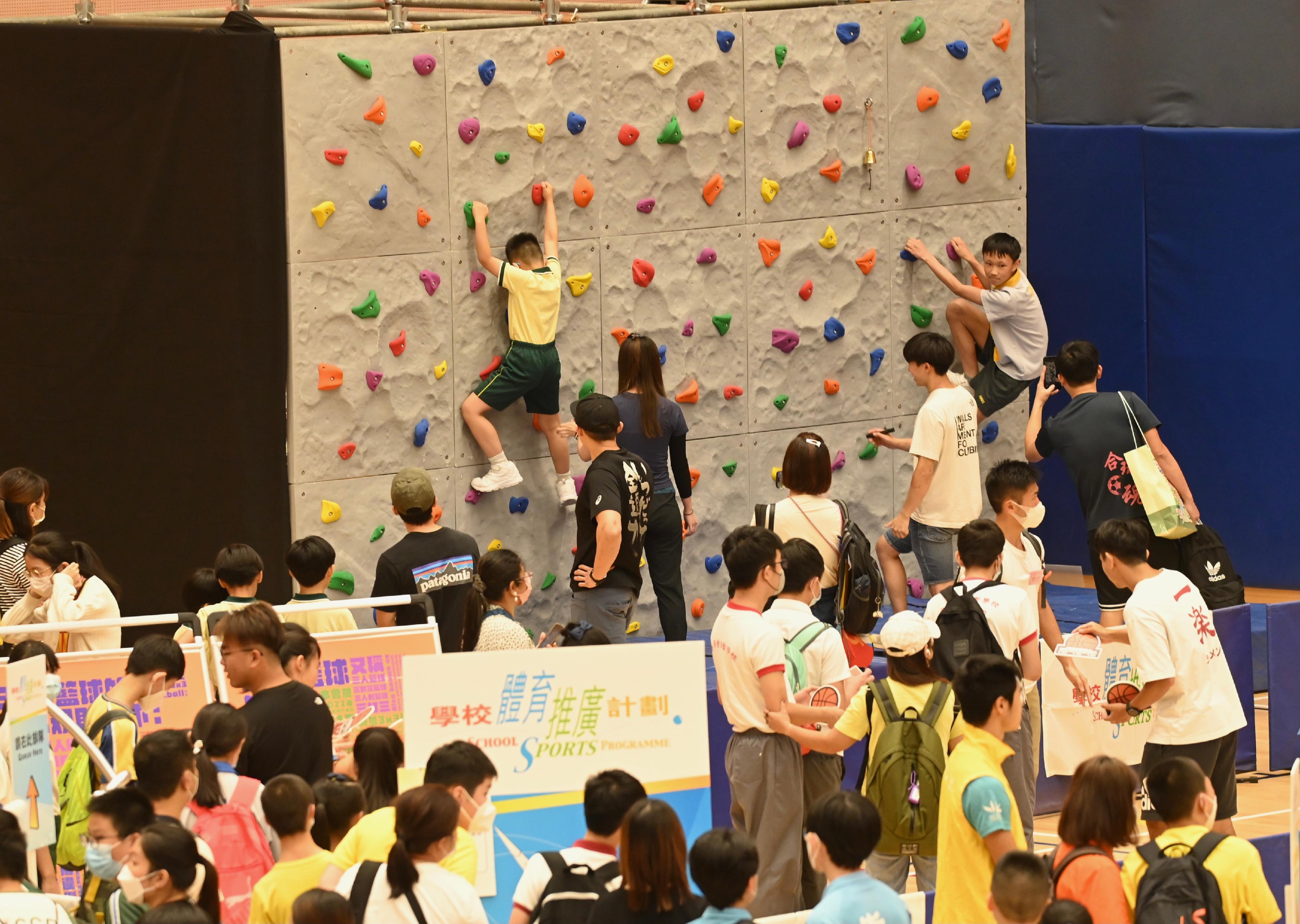 康樂及文化事務署今日（七月七日）在中山紀念公園體育館舉行2023學校體育推廣計劃頒獎典禮暨嘉年華。圖示學生參與運動攀登運動同樂活動。