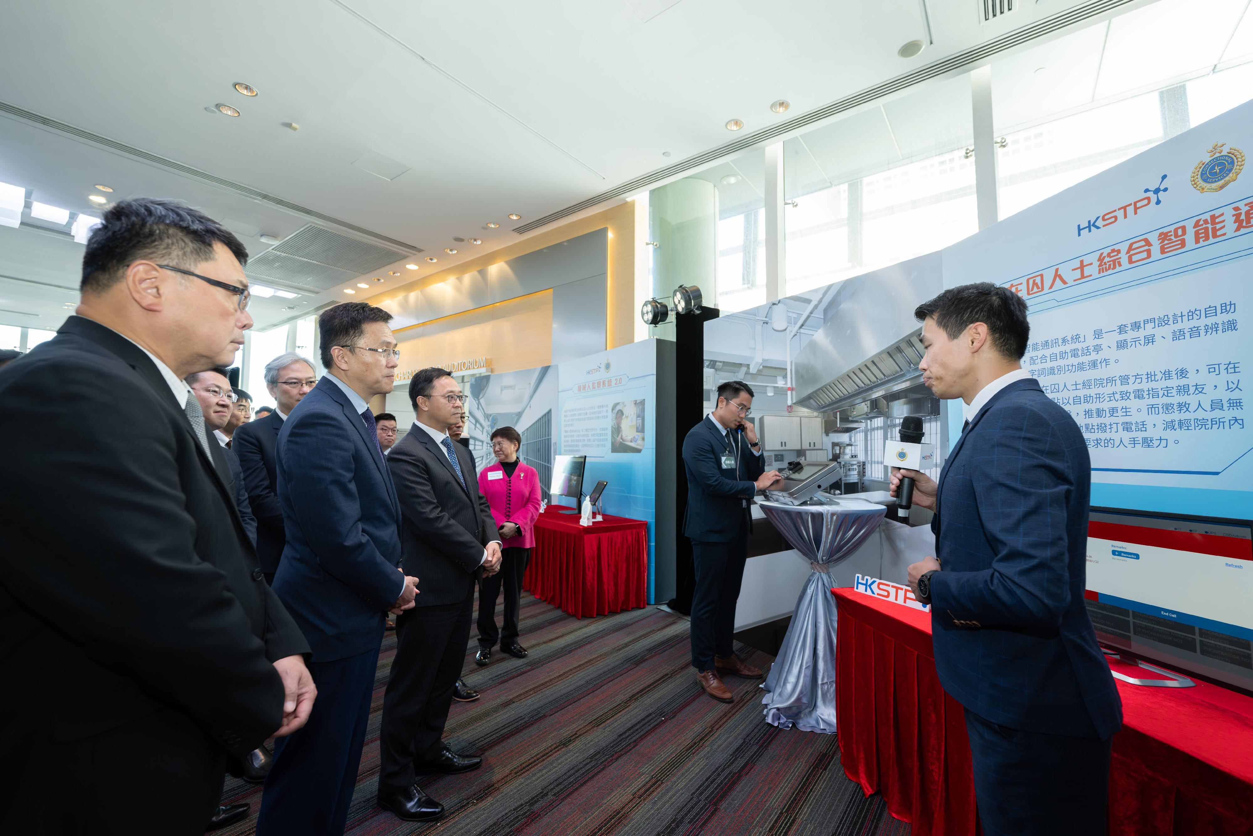 The Correctional Services Department and the Hong Kong Science and Technology Parks Corporation (HKSTP) signed a Memorandum of Understanding today (July 11) to deepen their co-operation, which will inject new impetus into the sustainable development of "Smart Prison". Photo shows the Secretary for Innovation, Technology and Industry, Professor Sun Dong (second left), accompanied by the Commissioner of Correctional Services, Mr Wong Kwok-hing (third left), and the Chairman of the HKSTP, Dr Sunny Chai (first left), being briefed by a correctional officer, on an innovation and technology project of "Smart Prison".