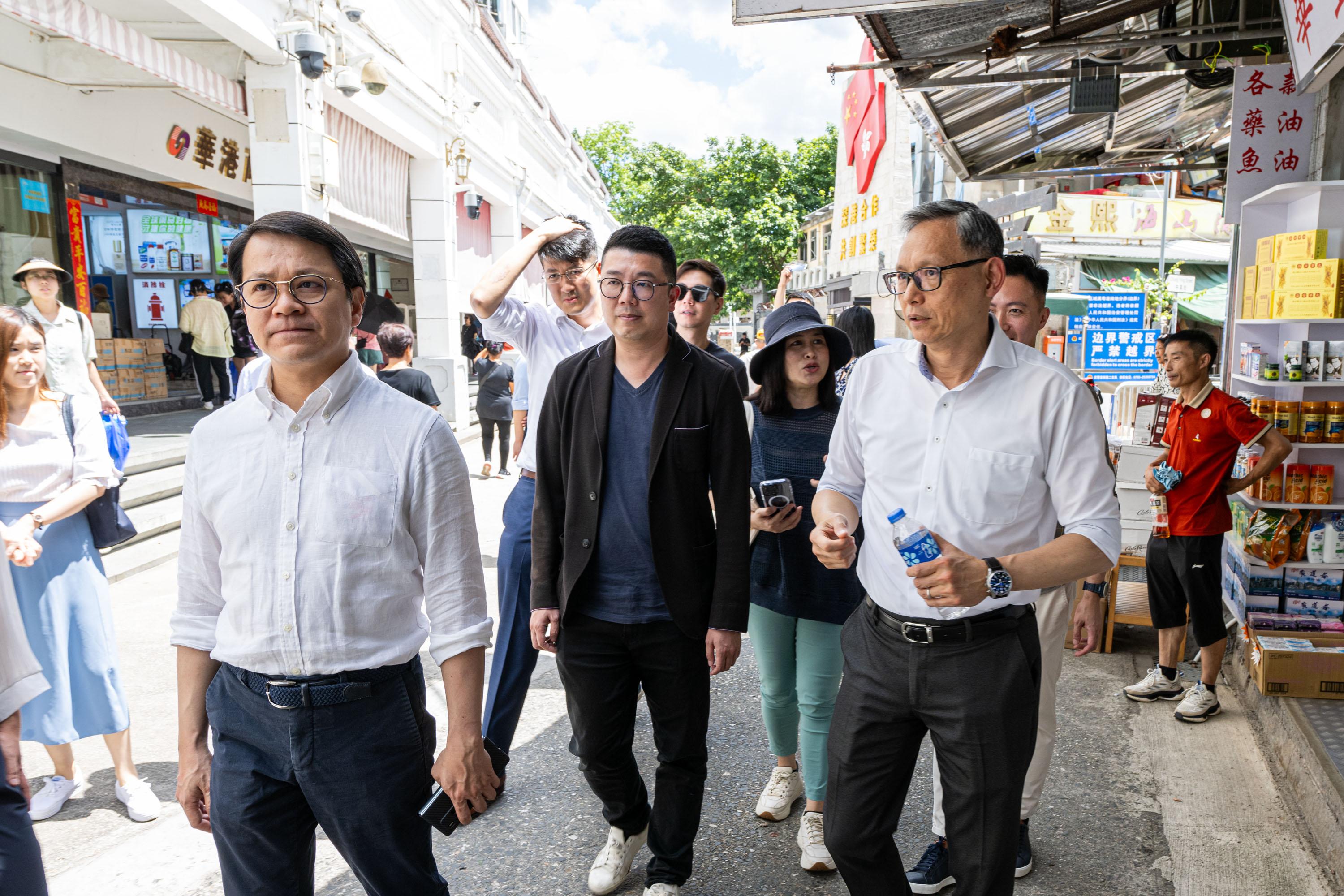 The Legislative Council (LegCo) Panel on Security visits Sha Tau Kok and Liantang/Heung Yuen Wai Boundary Control Point today (July 11). Photo shows the Chairman of the Panel on Security, Mr Chan Hak-kan (first left) and other Members visiting Chung Ying Street in Sha Tau Kok and receiving a briefing from the Under Secretary for Security, Mr Michael Cheuk (first right), on the plan to gradually open up Sha Tau Kok.